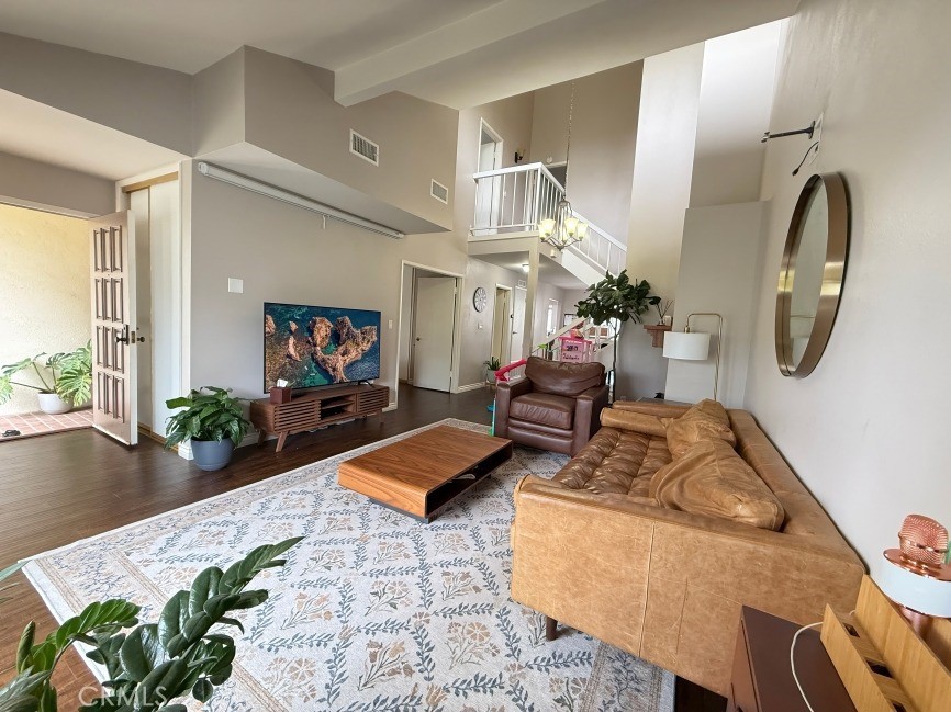 This updated townhome is nestled in the highly desirable Mira Verde community, moments from Peninsula Shopping Center. The main floor entry opens to a sunken living room with soaring ceilings, a fireplace, and sliding glass doors leading to a spacious private patio, ideal for indoor-outdoor living. Custom hardwood flooring and designer base molding flow throughout the home, complemented by upgraded doors and hardware. The remodeled kitchen features quartz countertops, newer stainless steel appliances, a cozy breakfast nook, and an adjacent bonus room perfect for casual dining or flexible use. A formal dining area and a main-floor office/den add versatility to the layout.
The primary suite includes a renovated bathroom with a separate soaking tub, walk-in shower, and a spacious walk-in closet. A large storage/bonus room adjacent to the two-car garage provides versatile space for storage.
The Mira Verde community provides resort-style amenities, including a swimming pool, spa, tennis/basketball courts, BBQ areas, and a clubhouse.