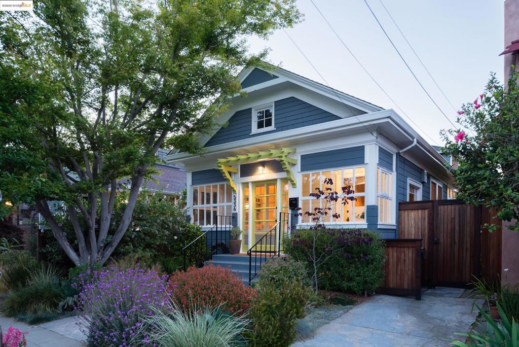 Tucked in one of Rockridge’s most desirable pockets, this masterfully renovated home pairs timeless charm with elevated modern living. A welcoming covered front porch invites you in, where rich hardwood floors, playful archways, and streams of natural light create a captivating ambiance throughout. The sunlit living room flows into a formal dining room anchored by a fireplace—ideal for cozy evenings or refined entertaining. At the heart of the home, the chef’s kitchen is a true showpiece: a Wolf range, prep island with seating and sink, built-in window seating, and inlaid wood cabinetry meet exquisite designer tilework, creating a space that’s both beautiful and highly functional. The upstairs primary suite is a luxurious retreat. A secondary bedroom and a versatile sun porch—perfect for a home office or occasional guests—add flexibility to the floorplan. Practicality meets elegance with a spacious laundry room. Outside, warm summer nights beckon. Enjoy dining alfresco, gardening or thoughtful conversations after a long day. Tucked away at the rear of the property, a detached guest suite with sleeping loft offers a serene hideaway for visitors or the ultimate work-from-home escape. Thoughtfully crafted and curated, this exceptional residence is a rare Rockridge offering.