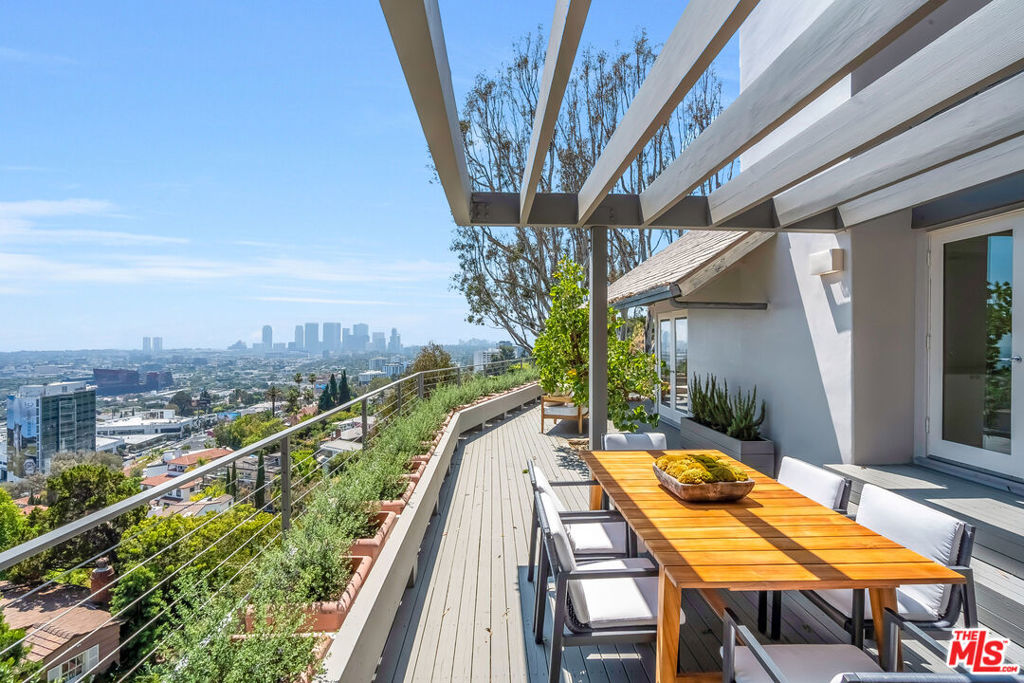 Welcome to "The Miller MCM," a mid-century modern gem perched on a striking overlook just above the Sunset Strip. THE VIEWS ARE UNINTERRUPTED. THESE VIEWS ARE EXCEPTIONAL AND RARE. From dawn to dusk, sweeping panoramic vistas stretch from the glittering skyline of Downtown Los Angeles to Century City and the Pacific Ocean, placing the city's most iconic views entirely at your fingertips. Bright, spacious interiors with high vaulted ceilings offer an architectural statement, blending Zen-inspired calm with mid-century modern elegance. The open kitchen, equipped with dual refrigerators and generous counter space, provides a perfect backdrop for entertaining against endless city-to-ocean panoramas. The top floor is a private master retreat, complete with expansive walk-in closets, a cozy fireplace, and a sun-drenched terrace capturing the horizon in every direction. A dedicated studio space offers a tranquil and creatively inspiring environment, ideal for yoga, meditation, or use as a home office. This is paired with a primary bathroom suite featuring a sauna, creating a sanctuary for wellness and reflection. Outside, secret garden enclaves and terraces provide privacy and serenity, while the expansive lot is perfectly oriented to frame the panoramic views and elevate the outdoor experience. "The Miller MCM" is more than a home, it's a canvas to manifest your private peaceful retreat, combining mid-century modern elegance, architectural creativity, and the dramatic panoramas of Los Angeles.