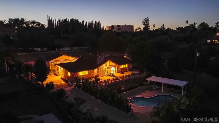 Welcome to 732 Hamilton Lane — your private Fallbrook retreat. This stunning single-level home offers 3 bedrooms and 3 bathrooms on 1.1 gated acres, designed for those who love both elegance and tranquility. Step inside to soaring vaulted ceilings and an open-concept layout that seamlessly connects the living, dining, and kitchen spaces—perfect for entertaining or relaxing with family. Large windows fill the home with natural light and capture sweeping views of the surrounding hills. The gourmet kitchen and spacious great room flow effortlessly to the outdoor living area, where a sparkling pool, covered patio, and lush landscaping create a true resort-style setting. Enjoy mature fruit trees, a four-car garage, and the peace of a fully private, gated property—all just minutes from Fallbrook’s charming village. Experience the best of Southern California living at 732 Hamilton Lane—where style, space, and serenity meet.