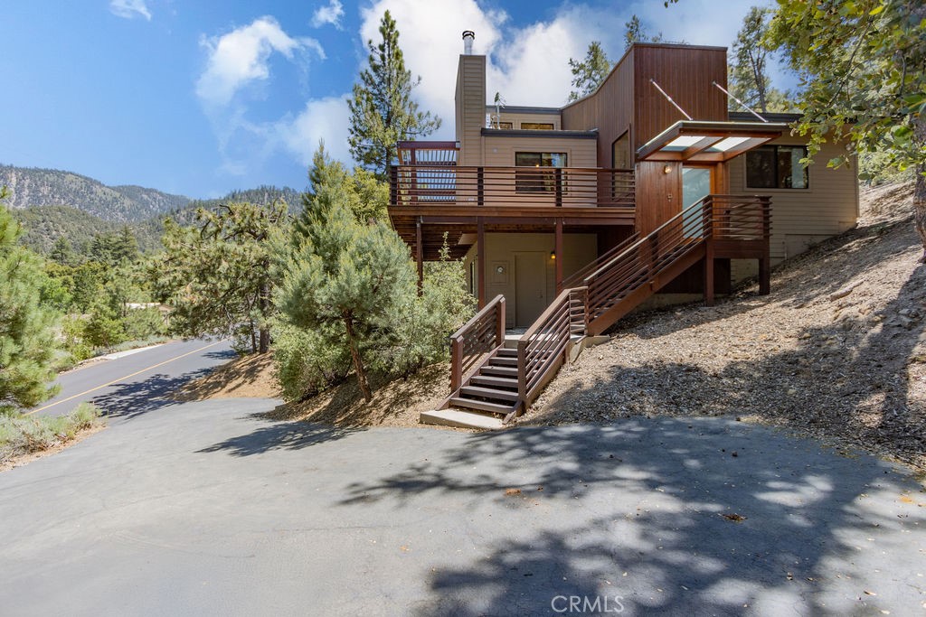 Discover a truly unique retreat at 1917 Freeman Drive in Pine Mountain Club, California. This one-of-a-kind home, designed by architect David Cooper and built by general contractor Pat Kearney, offers a harmonious blend of craftsmanship and natural beauty.
Nestled within the serene embrace of 1.7 million acres of National Forest, this property boasts easy access and backs directly onto peaceful greenspace. A paved driveway and ample parking ensure convenience.
The charming 1-bedroom, 1-bathroom residence features high ceilings with exquisite tongue and groove detailing, creating an open and airy atmosphere. Enjoy cozy evenings by the wood-burning fireplace in the living room, or rely on the efficient propane forced air unit for warmth.
Thoughtful design maximizes natural light with a strategically positioned skylight and recessed lighting throughout. Unique sun shades over the deck and front door add a distinctive touch. This home also includes a large workshop with laundry hookups and a water softener, providing practical amenities for comfortable living.
Come take a look, maybe this is a dream come true.