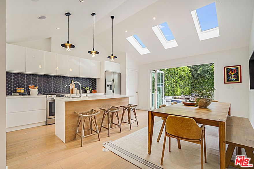 Sanctuary in the City! Welcome home to a hip 3BR/2BA hideaway nestled in the hills of Garvanza! Bathe in sunlight from the moment of entry, large skylights and vaulted ceilings amplify the breezy open floor plan and CA indoor/outdoor flow. Sleek flat-front cabinet design with chevron backsplash detail and large kitchen island with oak detailing make for the perfect food prep and entertaining experience. Ample kitchen/dining area with bifold doors to massive backyard brings the outdoors in! Master suite offers skylights and vaulted ceilings, too with sliding door access to backyard, plus a custom walkthrough closet and modern bathroom, boasting floating dual vanity and oversized tile shower. Two ample guest bedrooms, plus fresh subway tile hall bath provide plenty of guest accommodations. Bonus backyard studio shed makes a great office space, with concrete floors, sliding doors and tons of light. Oversized yard twinkles at the golden hour, featuring privacy plantings and plenty of room to run, play, and add a pool!