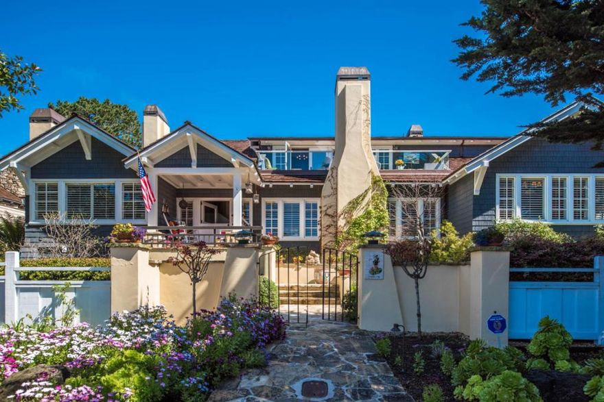 Grand ocean view craftsman-style home masterfully upgraded over the years, impeccably maintained and sited on nearly a triple lot just two blocks to the beach.  Lush gardens surround the home and provide a variety of areas to soak up the Carmel sun. When the sun disappears, stay warm by one of the six fireplaces, each carefully adorned with a custom stone fascia and spread thoughtfully throughout the home. Relax in the ocean view family room which leads out to a spacious deck, the perfect respite from where to view the sunset under the Pacific horizon. Notable features include oak floors, beamed ceilings, over 4,200 sqft of living space plus a large finished basement with a 1,500 bottle wine cellar, 2-car garage all on over a quarter acre. Live the estate life just steps from the beach right here in Carmel.