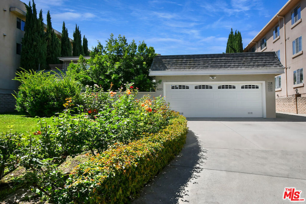 Welcome to 14128 Dickens Street in Sherman Oaks, CA a rare townhouse-style residence tucked away in the picturesque Stansbury Estates. Part of an intimate, well-maintained complex of just five homes, this is truly the crown jewel: a private retreat that lives like a single-family home, moments from Whole Foods, top restaurants, and upscale shopping. Step inside to an impressive foyer featuring a charming tile mosaic, soaring ceilings with chandelier and shiplap detail, and a convenient coat closet. From here, the eye is drawn through the expansive living space to French doors framing the lush greenery of your private backyard. The open-concept living and dining areas flow effortlessly together, creating an inviting atmosphere ideal for everyday living or entertaining. Walls of French doors flood the space with natural light and open to a tranquil garden patio, delivering that coveted indoor-outdoor California lifestyle. The kitchen is a chef's dream with a central island, abundant counter space, extensive cabinetry, elegant stainless steel appliances, and direct access to the two-car garage. Completing the main level is a cozy den or media room with a built-in aquarium and French doors to the patio, plus a spacious downstairs suite perfect as a home office or future primary bedroom complete with its own three-quarter bath. Upstairs, two generous bedroom suites each feature their own bath. The luxurious primary retreat includes serene green views, a spa-like bathroom with quartz finishes, frameless glass shower, soaking tub, dual vanity, and a massive walk-in closet with wood floors and hidden attic storage. Outdoors, the private patio is enclosed by tall Podocarpus trees, offering a peaceful setting for morning coffee, along with a charming planter for the avid gardener. 14128 Dickens is a rare gem equally suited as a pied--terre or forever home in a prime Sherman Oaks location. Don't miss your chance to experience it.