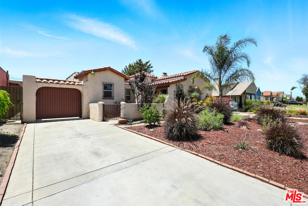 Wow! Large stunningly remodeled Spanish Revival home nestled in a quiet, well-established pocket of Los Angeles. This spacious 4-bedroom, 3-bathroom + huge den residence seamlessly blends timeless architectural character with modern upgrades. Step inside to a light-filled living room featuring a beautiful decorative fireplace, arched entryways, and updated wood flooring throughout. The gourmet kitchen has been thoughtfully renovated with quartz countertops, custom cabinetry, and stainless-steel appliances ideal for home chefs and entertainers alike. Enjoy flexible living with a large bonus den perfect for a media room, home office, or playroom. Upstairs, retreat to the expansive primary suite complete with an ensuite bathroom for your own private sanctuary. 3 of the bedrooms are downstairs including 1 bedroom with an ensuite bathroom. The layout offers versatility for multi-generational living, guests, or work-from-home needs. Outside, the backyard provides a great space for gatherings, gardening, or relaxing. Located in a sought-after neighborhood near Inglewood, this home offers convenient access to SoFi Stadium, The Forum, LAX, the upcoming Crenshaw/LAX Metro Line, and major freeways. Enjoy being minutes from shopping, dining, and entertainment, all while feeling tucked away on a peaceful residential street. Kitchen Includes brand new Oven/Stove, Microwave, Dishwasher and Fridge. Easy to show!