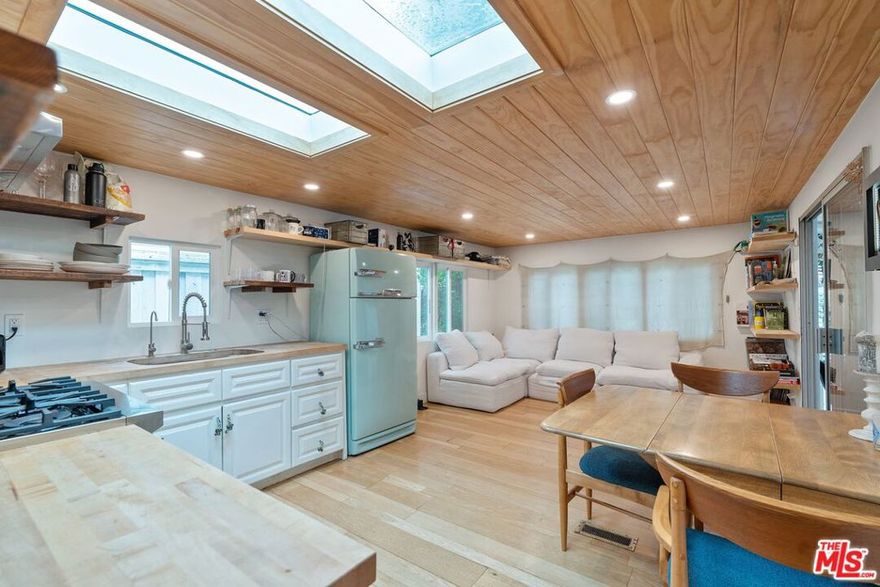 One of Paradise Cove's coolest beach bungalows, this 2br, 1.5ba home in the lower bowl of the exclusive beachfront park offers an iconic retro-Malibu vibe, thoughtful bespoke design, and low space rent.  Large skylights and recessed lighting throughout create a bright, airy vibe, and the spacious living/dining area features stylish fixtures and striking exposed shelving. Special details are found everywhere, from the live-edge wood to the hand-done tongue-in-groove ceilings. Step outside to enjoy an expansive creekside deck with an outdoor shower, and plenty of space for surfboards. The house was remodeled with new insulation, electrics, and sturdy construction, and the lot has room for expansion and added height. This property is the ultimate in oceanside living, offering direct access to Paradise Cove's world-renowned beaches, plus the park's incredible amenities - including tennis/basketball courts, security, playground, clubhouse, community garden, and truly world-class views.