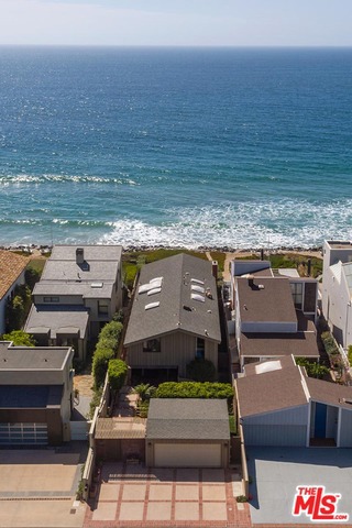 Beachfront home with 40 feet of frontage and panoramic coastline and whitewater views on Malibu's exclusive, star-studded Broad Beach Road. Enter through a charming courtyard to find a cozy two-story four bedroom, four bath post and beam house. The main level features a large chef's kitchen with skylights above that send natural light throughout the main floor. An expansive entertainment area opens to a huge private oceanfront patio, perfect for entertaining and outdoor dining with an easy access window from the wet bar inside. Rare opportunity to acquire a property at this price on this prime section of Broad Beach.