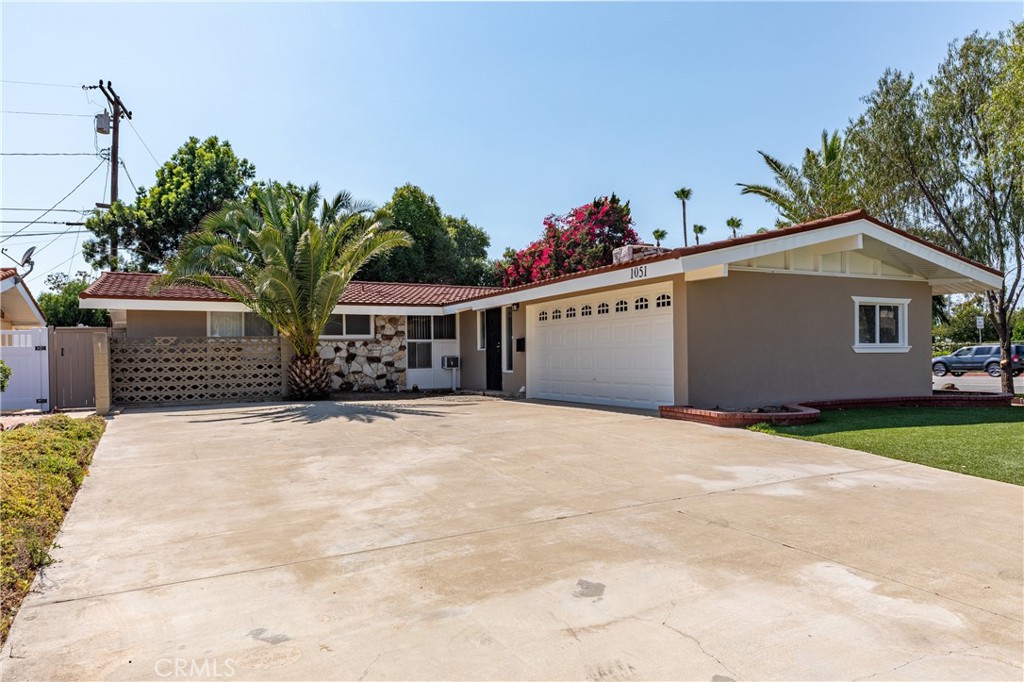 This 3-bedroom, 1.5-bathroom home offers 1,053 sq ft of living space on a 6,500 sq ft corner lot in the Anaheim Union School District. Featuring wood flooring throughout, with vinyl flooring in the bathrooms and kitchen, with fresh exterior and interior paint. The home also includes a comfortable living room with a fireplace and ceiling fans in living room and bedrooms. The washing machine hookups are in the kitchen and the dryer hookups are in the garage.The primary bedroom includes a private half bathroom. The front yard features artificial turf.
Additional features include central heating, a detached 2-car garage, and a large backyard with room to customize or enjoy as-is. Conveniently located near the 5 and 91 freeways, and just minutes from shopping, dining, and Anaheim's popular attractions.