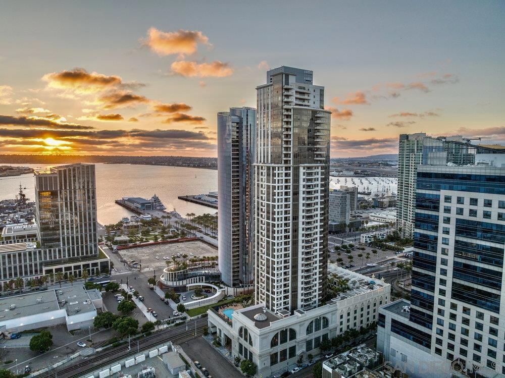 Highly coveted 04 floorplan at Electra! Perched high above the city, Residence 2404 in the iconic Electra building showcases panoramic views of Downtown San Diego and the Bay, with two private balconies that capture the energy of the waterfront and skyline. The spacious living and kitchen area is surrounded by walls of glass, offering a front-row seat to the breathtaking views and the vibrant rhythm of downtown life. High-end stainless steel appliances, a Maytag dishwasher, and a sleek pull-out faucet combine functionality with elegance, while an in unit washer and dryer—complete with upgraded in-unit shut-off valves—bring everyday convenience. The primary suite is a serene retreat with its own private balcony overlooking the ocean. The newly reimagined spa-inspired bathroom features dual shower heads and handhelds, dual vanities, and a luminous backlit mirror, all designed with sophisticated modern finishes. A custom California Closet completes the space with style and organization. With TWO PREMIUM PARKING SPACES and a private storage unit, this residence pairs comfort with convenience. Ideally located near Little Italy, Electra 2404 embodies the essence of refined downtown living.