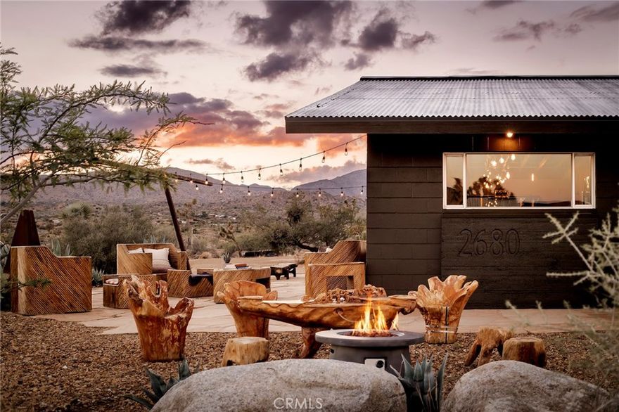 Surrounded by ancient boulders, lava buttes, and panoramic vistas of Pioneertown’s dramatic ridgelines, this 40-acre ranch offers a rare combination of natural

beauty, privacy, and convenience, just minutes from Pappy & Harriet’s, Joshua Tree National Park, and the heartbeat of Pioneertown. Every area of the home

captures a different, breathtaking view of the surrounding desert and mountains, making the property as inspiring indoors as it is outdoors. Already one year into

the subdivision process, the 40-acre parcel is being divided into multiple opportunities: 20 acres encompassing the main house, detached garage with office,

original 1932 homestead cabin, and stables, plus one 6-acre parcel and two 7-acre parcels. Easements are in place, and nearby electric poles provide future utility

access, making this not only a lifestyle compound but also an investment with substantial upside. The main residence spans 1,527 sqft with 2 bedrooms, 1

bathroom, and a bonus office space located off the 2.5 car garage. Venetian plaster walls, a newly remodeled bath with Italian and Moroccan finishes, and a chef’s

kitchen with butcher block island and KitchenAid appliances blend rustic authenticity with modern comfort. A wood-burning fireplace with NuTone blowers and

Solar power (while still on-grid) that’s paid for. The original 1932 homestead cabin (313 sqft) serves as a charming 1-bedroom, 1-bath retreat with full kitchen,

soaking tub, and dipping pool. Offering flexible options for guests, creative use, or additional income. Outdoor amenities include a cowboy hot tub beneath desert

skies, an airplane engine pool, a horse corral, chicken coop with egg-laying hens, a playhouse, bike track, and garden room. This property is as much a retreat as it

is an opportunity, a working ranch and a long-term investment poised for its next chapter.