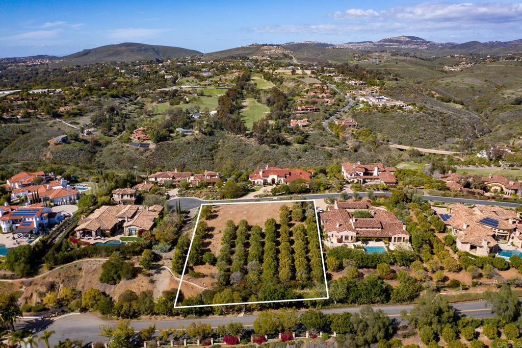 Situated within the prestigious gates of The Bridges at Rancho Santa Fe, this exceptional south facing one-acre vacant lot offers a unique opportunity to build in one of San Diego's most exclusive private golf communities. Enveloped by mature orange groves, this property promises an unparalleled setting of tranquility and privacy. The building area is a blank canvas, perfectly primed for your architectural vision to come to life. The lot beckons those who desire exclusivity and the opportunity to create a home tailored to their lifestyle. Imagine designing a residence that complements the serene surroundings while capitalizing on views. Whether your dream includes expansive entertainment spaces, serene outdoor retreats, or a sophisticated sanctuary, this property provides the flexibility and space to make it a reality. This distinguished community promises a lifestyle of luxury and leisure with its private world-class amenities and impeccable service, and security. Embrace the chance to craft your dream home in a community renowned for elegance and exclusivity. The Bridges at Rancho Santa Fe awaits your vision.