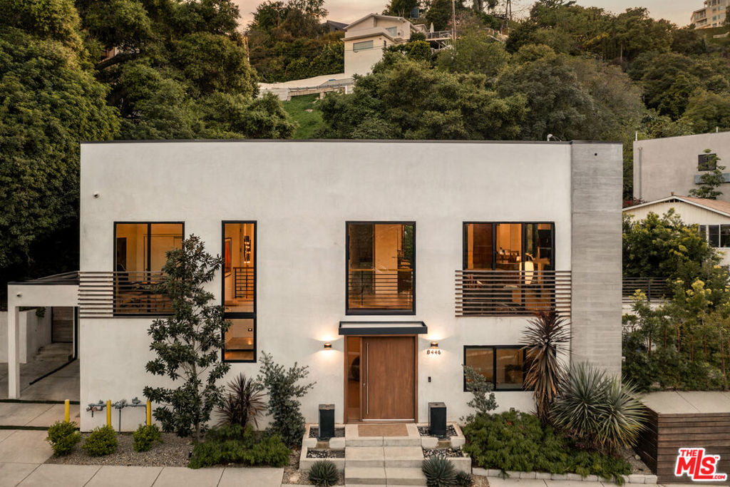 Tucked away in the iconic hills of Laurel Canyon, this newly rebranded architectural estate delivers a bold yet refined take on elevated California living. Blending privacy, sophistication, and an effortless indoor-outdoor flow, the home offers a one-of-a-kind sanctuary just minutes from the energy of the Sunset Strip. With five bedrooms and a thoughtfully redesigned layout, every inch of this gated property feels intentional, inviting, and ready to impress.Step into the light-filled interiors where soaring double-height windows and a sleek floating staircase welcome you. The main level features an inviting living room bathed in natural light, ideal for hosting guests. Upstairs, a spacious great room combines living and dining areas with a cozy fireplace and expansive windows offering sweeping hillside views.The chef's kitchen is a culinary masterpiece, featuring a generous waterfall island, breakfast bar, and elegant stainless steel appliances complemented by a sophisticated mix of light and dark wood accents. Fold-away glass doors open to a private backyard sanctuary, complete with a resort-style pool, sun-drenched terraces, and an outdoor fireplaceperfect for both relaxing and entertaining.The primary suite is a haven of tranquility, boasting dual walk-in closets, a luxurious spa-style bath with a freestanding soaking tub, and direct access to the pool terrace. Additional highlights include versatile bedrooms that can serve as the perfect home office, theater, game room, or gym, each with its own unique design, and four and a half tastefully appointed baths.Other notable features include covered parking for one car and gated parking for up to four vehicles, an advanced network system, full Sonos multi-room audio, and complete home automation compatible with Apple HomeKit, with options for upgrading to Savant or Control4 systems.Enjoy the convenience of this exclusive hillside location, just minutes away from Laurel Canyon Blvd and the vibrant entertainment, dining, and shopping options of the Sunset Strip.