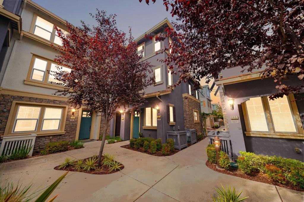 End unit, desirable location within the community, premium builder upgrades, and top-rated schools...this home is a must-see! The flexible layout begins with a private ground-floor bedroom and full bath. On the main level, natural light fills the open-concept living and dining area, seamlessly connected to a balcony. The gourmet kitchen features a gas range, large island, ample counter space, and abundant cabinetry for everyday cooking and entertaining. Upstairs, the primary suite offers a relaxing retreat with a walk-in closet and a thoughtfully designed en-suite bath. The second upstairs bedroom also has full bath and walk-in closet, providing comfort and privacy for everyone. Additional highlights include an interior laundry room, dual-zone heat & cool, tankless water heater, water softener, plus two-car garage w EV charging. This home is further enhanced by custom California Closets, Hunter Douglas shutters, and powered shades on the main floor. Community amenities include a clubhouse, playground, dog park, and lush courtyard spaces all just minutes from downtown Sunnyvale, Caltrain, shopping, dining, and top tech campuses.With extensive upgrades, a premium end-unit location, and modern design, this home is a rare opportunity to enjoy the best of Silicon Valley living.