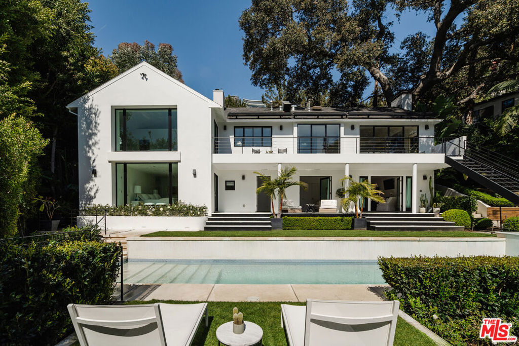 1558 Sunset Plaza Drive represents contemporary Hollywood Hills living at its finest. This meticulously renovated 3,250-square-foot home offers four bedrooms, three-and-a-half bathrooms, and a thoughtful design that prioritizes light, views, and the seamless indoor-outdoor lifestyle that defines Southern California.Custom steel windows and doors throughout create walls of glass that frame stunning vistas while flooding the interior with natural light. The open floor plan connects spacious living and dining roomsboth featuring custom built-insto a covered patio with electric shade. The adjacent family room features one of three wood-burning fireplaces, creating warmth and ambiance. A formal dining area and bar provide versatility for entertaining.The gourmet kitchen delivers both style and function with Sub-Zero and Wolf appliances, built-in breakfast bar, and ample storageall wrapped in a sophisticated neutral palette.A standout feature: two expansive primary suites. The main suite on the lower level offers south-facing garden views, custom fireplace, walk-in closet, direct patio and pool access, and a private dry sauna. The upper-level primary suite provides garden views, privacy, and a beautifully appointed bathroomperfect for guests or multi-generational living.The outdoor spaces truly elevate this property. Surrounded by mature landscaping for maximum privacy, the backyard features a 40-foot chemical-free swimmers pool, outdoor BBQ area, and breathtaking jetliner views expertly framed by thoughtful landscaping.Additional features include two-car garage with street parking, state-of-the-art security, central HVAC, laundry room, original hardwood floors throughout, and newly updated Carrara marble bathrooms with Dornbracht fixtures.Located minutes from the Sunset Strip and Beverly Hills, this home offers the perfect balance of peaceful privacy and urban accessibilitya true Hollywood Hills sanctuary that's move-in ready and designed for modern living.