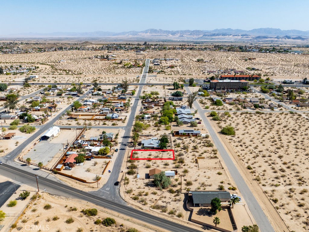 ***Priced To Sell***Fabulous lot on paved road and stone’s throw away from 29 Palms Hwy. It’s zoned RS-4 (Single-Family Residential – 4du/ac) which allows a single family dwelling and possibly an ADU. Power lines are in the back of the property and other utilities are nearby. Will need a septic tank which is common in the area. This is really an unique opportunity to enjoy a peaceful desert lifestyle with breathtaking natural beauty. 29 Palms has been enjoying a robust growth in recent years with lots of new businesses opening up and population continued to increase. Do not miss this opportunity to make your dream come true on this blank canvas. Please note that the boundaries represented in the photos are only an estimation.
