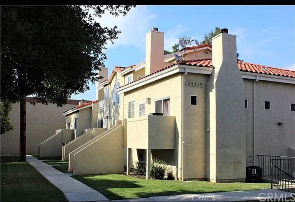 Nestled in a beautiful and tranquil pocket of Newhall, this spacious 2-bedroom, 2-bath corner condo offers comfort, convenience, and privacy. With an attached 2-car garage, this move-in ready home is perfect for easy living. Step inside to find brand new carpet and a cozy fireplace in the living room, creating a warm and inviting atmosphere. Enjoy your morning coffee or evening breeze on the quaint balcony just off the main living space.
The primary suite is a private retreat, while the second bedroom offers flexibility for guests, an office, or more. The laundry area, located in the garage, includes a washer and dryer, plus generous storage throughout the home. Located just a short stroll from Lyons Avenue, you'll have easy access to local shopping, dining, and all the charm that Newhall has to offer.