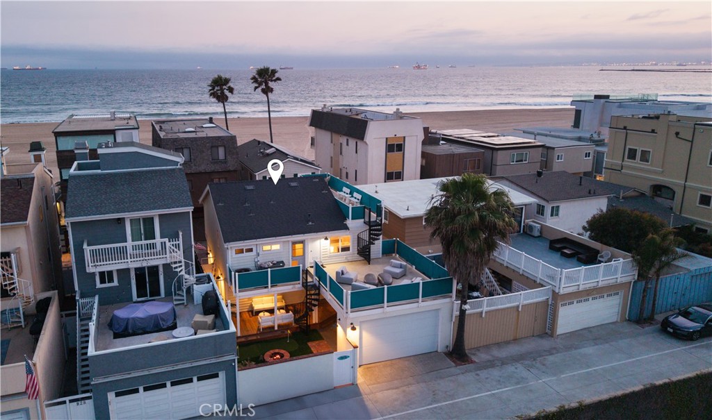 Live the ultimate coastal lifestyle in the exclusive, guard-gated community of Surfside—where ocean views, sea breezes, and sandy toes come standard. Rarely available, this beautifully updated home is situated on an oversized 39’ wide lot with a private backyard, offering a spacious layout rarely found in this beachfront enclave.
Inside, an open-concept floor plan is filled with natural light and framed by ocean-facing windows. The expanded chef’s kitchen features modern appliances, white cabinetry, a custom teak prep center, and stylish pendant lighting. Entertain effortlessly with a seamless flow from the dining room to an indoor/outdoor teak wet bar—perfect for hosting after-beach cocktails.
Warm hardwood floors continue through the private living quarters, which include generous walk-in closets and sun-filled spaces. Enjoy morning coffee on your balcony or unwind on the expansive back deck with views and fresh ocean air.
Additional features include a finished attic for extra storage, a two-car attached garage, and two dedicated parking spots. Direct beach access is just steps away from the side of the home. There’s even room to add square footage, making this not only a dream home but a great investment.
Don’t miss your chance to own this rare gem in Surfside. Coastal luxury, privacy, and space—it’s all here.