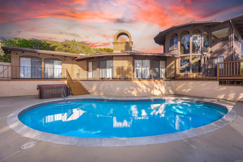 Experience the epitome of timeless elegance with this stunning Adobe residence crafted by Weir Brothers, offering breathtaking ocean vistas. Situated on a spacious 0.28-acre corner lot just three blocks from the pristine beaches of Del Mar, this exquisite 3-bedroom, 3-bathroom home encompasses 3,437 square feet of refined design and masterful craftsmanship. A gated entry leads to a welcoming courtyard, opening seamlessly to arched doorways that invite you inside. The interior is illuminated by graceful Gothic-style chandeliers and light fixtures, highlighting the open-concept family room and spectacular ocean views. The spacious living areas include a formal dining room, a cozy breakfast nook, a generous family room, and an elegant loft/library—each capturing the serene coastal landscape. The primary suite boasts dual vanities, separate closets, and panoramic ocean views, creating a private retreat. Outdoors, enjoy wrap-around decks nestled among mature pines and overlooking the sparkling ocean. The meticulously landscaped yard features a pool and Jacuzzi, perfect for summer entertaining, as well as a tranquil side yard with mature plantings and a peaceful sitting area. Additional amenities include a brand-new refrigerator and washer and dryer, all included in the lease. This distinguished family home seamlessly combines enduring architectural beauty with modern comforts, embodying the iconic beachside lifestyle of Del Mar.