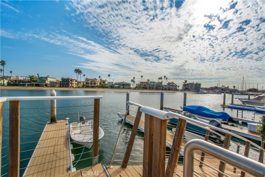 Waterfront Living on Treasure Island | Naples, Long Beach. Tucked away on one of the most coveted stretches of Treasure Island in Naples, this waterfront residence captures the essence of Southern California coastal living. With 3 bedrooms, 2.5 bathrooms, and a coveted 45-foot-wide lot spanning 1.5 parcels, the home offers a rare combination of scale, charm, and lifestyle. A newly improved dock accommodates multiple boats—whether it’s a yacht, Duffy, or paddleboards—making harbor adventures effortless. The home’s rear patio and garden provide a private, tranquil retreat, ideal for alfresco dining and relaxed entertaining after a day on the water. Inside, sunlit living spaces flow seamlessly to the waterfront, maximizing views and connectivity to the outdoors. All three bedrooms are thoughtfully located upstairs, creating a private retreat from the home’s social spaces.

Just beyond your door, enjoy the vibrant lifestyle of Naples—stroll the canals, dine at waterfront restaurants, or cruise the bay at sunset. This Treasure Island property embodies the very best of Long Beach coastal living, blending modern functionality with timeless charm.