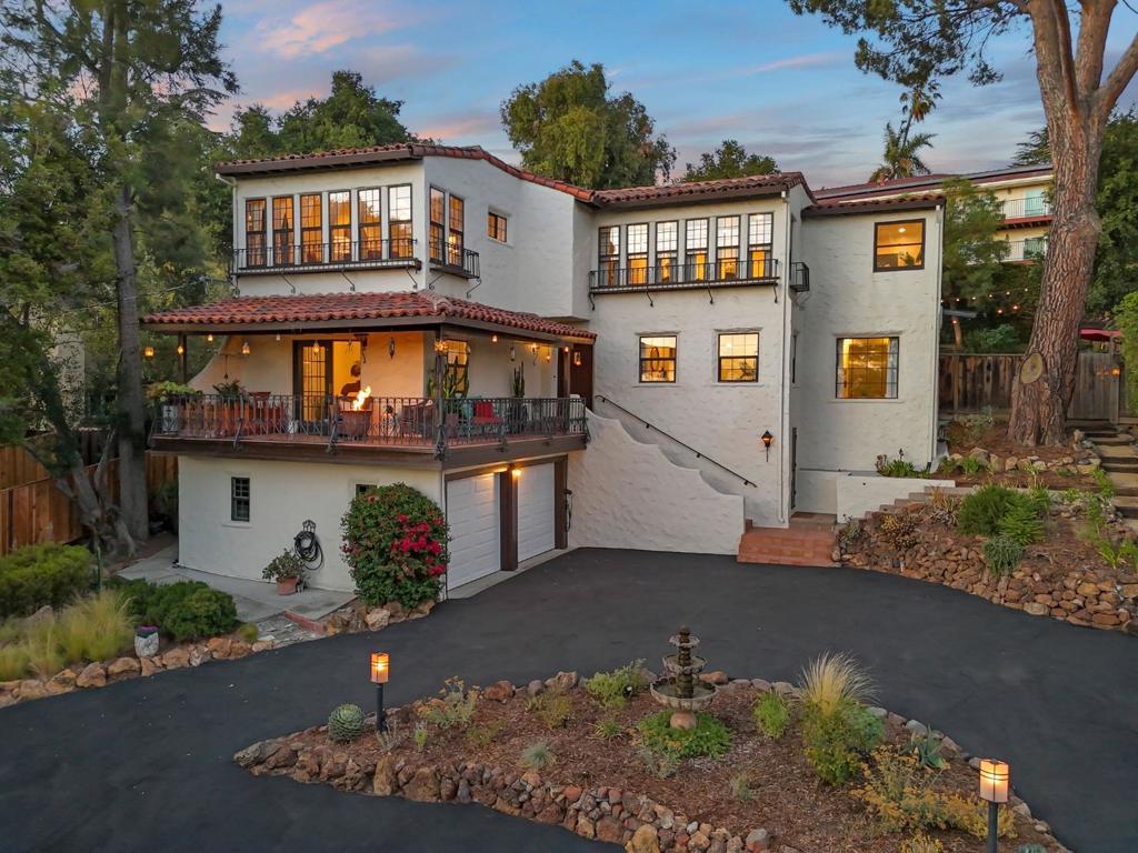 Nestled in the Hillcrest community, this 1920s Spanish masterpiece exudes historic charm & timeless character. Surrounded by mature trees, offers the perfect setting for a private, exquisitely preserved oasis. Enter through the original wood door with antique hardware & discover rare, 100-year-old locally made tiles- an architectural treasure unique to Hillcrest homes. The bright, open kitchen is fully equipped with stainless steel appliances, while the spacious living room features wood-beam ceilings, a gas fireplace, & French doors opening to a balcony with breathtaking views & a fire pit for sunset gatherings. The main floor includes a beautifully updated bath with luxurious Azul Bahia granite & a versatile bedroom with direct backyard access, ideal for guests or a home office. Upstairs, the primary suite & two additional bedrooms offer sweeping views, along with a second updated bath featuring a vintage tub. A large laundry room with sink & a flexible sitting/office space complete the top floor. The entertainers backyard boasts multiple seating areas, a large dining patio with sink, smart lighting, a custom-built shed, and a cozy wine cellar. Additional highlights include massive driveway, two-car garage, EV charger & close proximity to the prestigious San Jose Country Club.