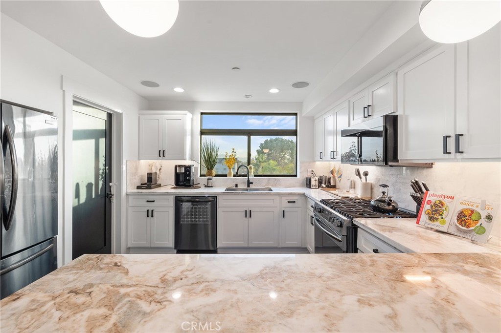 Welcome to 11324 W Raitt Lane—a stunning, modern residence built in 2021, perfectly situated in the heart of North Hollywood. This four-story, 3-bedroom, 4-bathroom home offers 1,847 square feet of stylish living space, including an oversized loft that adds versatility and charm to this thoughtfully designed property. Spread across four levels of sleek contemporary architecture, the home combines luxury finishes with the latest in smart-home technology. Upon entry, you’re welcomed into a bright and spacious interior where high ceilings and an open floor plan create a seamless flow between living areas. The expansive loft provides the ideal space for a home office, creative studio, playroom, or media lounge—tailored to your lifestyle. The chef-inspired kitchen features elegant countertops and a generous island, perfect for cooking, entertaining, or gathering with friends and family. High-end finishes and attention to detail are evident throughout the home, enhancing its overall sophistication. Tech-forward amenities elevate daily living, including an integrated in-ceiling Sonos sound system for rich, immersive audio throughout the home. The Brilliant Home Smart System gives you intuitive control of lighting, music, and other smart features, while the Ring Alarm Smart Home Package and Schlage Encode Door Lock provide peace of mind with enhanced security. Additionally, the Lutron Smart Home Package allows you to manage lighting and window shades with ease, adding both comfort and convenience. Enjoy two private outdoor spaces that invite relaxation. The floating stairs lead you to a secluded balcony just off the loft—an ideal spot to take in sweeping views of the city and mountains. Whether sipping your morning coffee or unwinding at sunset, this tranquil perch is a true retreat. Natural light fills the home, complementing its refined indoor and outdoor living spaces. Located near vibrant shopping, dining, and entertainment destinations, including the NoHo Arts District and NoHo West, 11324 W Raitt Lane offers the ultimate blend of luxury, smart living, and urban accessibility. Don’t miss the opportunity to experience this exceptional North Hollywood residence—schedule your private showing today!
