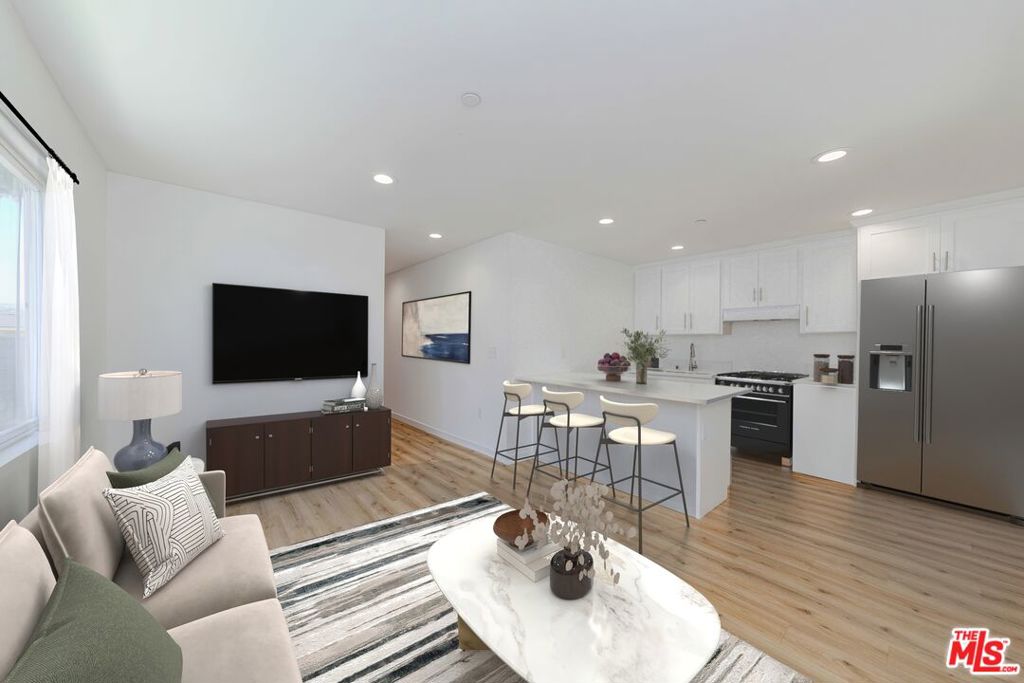 EXCELLENT INVESTMENT OPPORTUNITY! NEWLY BUILT Ground Up in 2022! Welcome home to this affordably-priced 2022 built contemporary single-family, two-story, move-in ready dwelling with detached ADU for additional income potential. In the heart of Los Angeles, pull into your private driveway or use the one-car garage and enjoy the modern open first floor plan you'll call home. Imagine having breakfast coffee at the sleek kitchen island or entertaining friends and hosting family holiday dinners in this open room style living/dining area with recessed lighting and a convenient powder room. Planned for privacy, the upstairs second story boasts two primary-size bedrooms, each with its own en suite contemporary bathroom. One of the bedrooms features sliding glass doors out to your private balcony where you can relax and enjoy our sunny CA weather. Bedroom two features a walk-in closet. This home has washer/drier hook-up, hardwood style floors, recessed lighting throughout and heating and air conditioning. Plus, out back, there's a bonus 1-bedroom, full bath ADU with heat/air conditioning, which is perfect for a family member or rental income. The solar panels are paid for making this an extra feature for low-cost electricity. Separate gas & electric meters for each unit. Best of all, is its location, location, location. Close to all major freeways, public transportation and the FREEDOM PLAZA boasting the best stores, restaurants, coffee shops, and landscaped walkable space. This property won't last. It qualifies for the DREAM HOME LOAN PROGRAM. Act now. *Furnished photos are virtually staged.