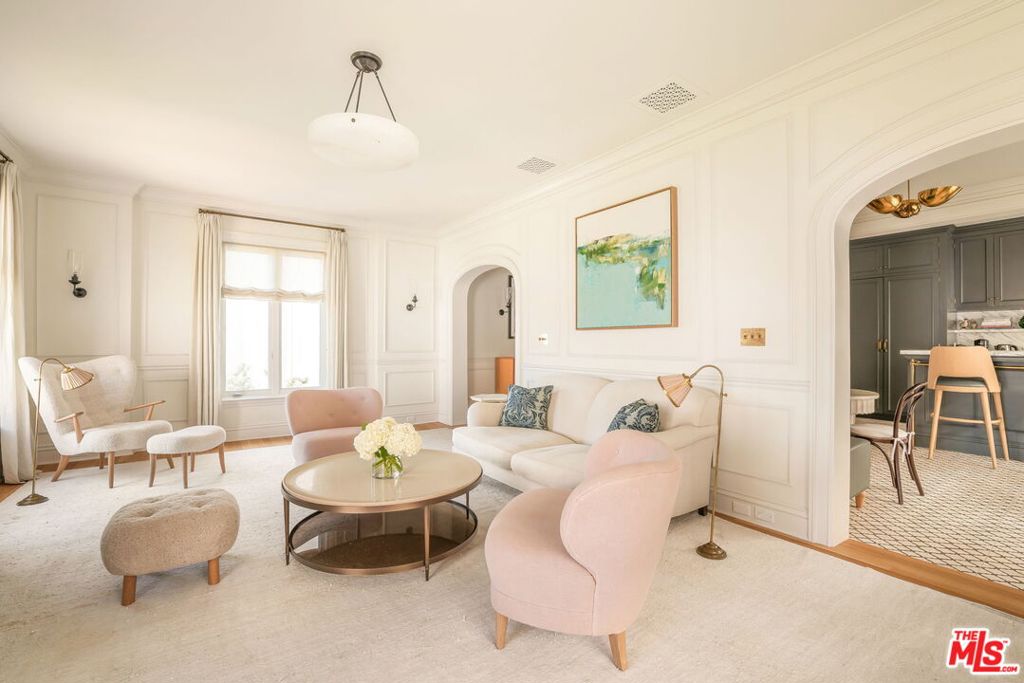 Presenting the most exquisitely designed, thoughtfully renovated residence in West Hollywood's full-service Granville Towers. This magnificently renovated fourth-floor home spans 1,177 square feet with one bedroom and one and a half bathrooms, and enjoys three exposures that fill the home with natural light throughout the day. No expense was spared in its transformation, from custom arches, molding, and paneling to a chef's kitchen with bespoke cabinetry and marble countertops, and a marble bathroom with custom brass shower enclosures and fixtures. The powder room is adorned with hand-painted de Gournay wallpaper, while abundant closet space, Bertazzoni appliances, and an in-unit stacked washer and dryer complete this extraordinary space. The top-to-bottom renovation includes new white oak flooring, plumbing fixtures by Catchpole & Rye, and Forbes & Lomax light switches. Lighting fixtures by Jamb London, Collier Webb, Kelly Wearstler, and Urban Archaeology are featured, as well as designer floor tile from Exquisite Surfaces. Custom linen treatments enhance every window. The Granville Towers is a historic French Normandy style condominium building in the heart of West Hollywood, originally built in 1930. Known for its dramatic turrets, lush gardens, and Old Hollywood charm, it has long attracted celebrities and creatives seeking privacy with character. Combining classic architecture with modern amenities, it remains one of the area's most iconic and prestigious residential addresses. Residents of The Granville enjoy gated underground parking, a secure gated entrance, and the services of a doorman, offering both safety and convenience. Perfectly situated, the building is close to West Hollywood's acclaimed restaurants, supermarkets, and vibrant nightlife. This unit can be sold fully furnished.