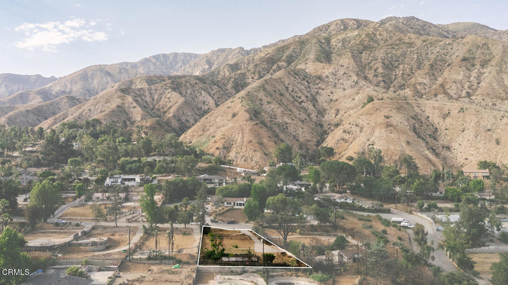 This approximately third of an acre lot towards the end of a quiet cul-de-sac features panoramic views of both the San Gabriel Mountains and the city below with its sparkling evening lights. The lot has a gentle incline with flat pads from the previous home which included a two story 1950s ranch-style house which measured 1,881 sq ft, attached lower level 405 sq ft guest house, and a separate three car garage which measured approximately 565 sq ft. Both the Phase 1 and Phase 2 cleanup have been completed on the property. The driveway remains intact. The street itself and surrounding neighborhood feature multiple standing homes and mature trees. It's located just blocks from several trailheads. Buyers are advised to verify future use and confirm necessary remediation steps with all government entities including the County of Los Angeles and any relevant agencies involved in the recovery and future building process. For safety reasons, access to the property is restricted to drive-by only. Please do not walk on site.