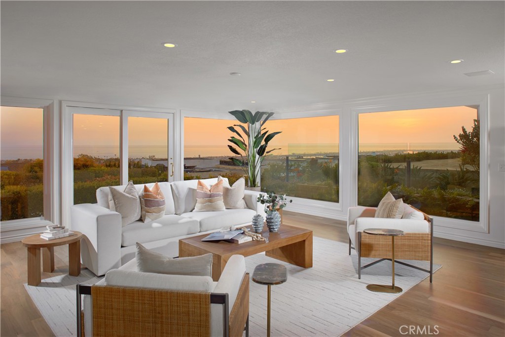 Live life as it is meant to be at this impeccably maintained and upgraded home in Corona del Mar’s desirable Harbor View Hills community. An expansive elevated homesite welcomes panoramic Pacific Ocean, city-light, Catalina Island and sunset views that also encompass the fairways of Pelican Hill and Newport Beach’s pier and harbor. Private and sophisticated, the single-level residence greets guests with a generously sized entry courtyard accented by a tranquil fountain. Double doors open to immediate ocean views that are framed by floor-to-ceiling windows in the living room and a separate den with built-in cabinetry. Leading to a view-enriched terrace, the living room shares a see-through fireplace with a dining room that offers garden vistas. The kitchen shines with Calacatta quartz countertops and full backsplash, stainless steel appliances, courtyard access, a garden window, peninsula, and white cabinetry with a built-in pantry. An open office is located just beyond the kitchen and features a built-in desk and cabinetry. Bright natural lighting accentuates the open design of the home, which extends approximately 3,173 square feet and hosts three bedrooms and three-and-one-half baths, including a casita with separate entrance off the courtyard and a vaulted ceiling. The secondary bedroom is impressively sized and boasts ocean views and a walk-in closet, while the primary suite opens to the view terrace through an elegant retreat and is distinguished by a garden-view shower, two sinks and ample wardrobe space. A 400-bottle wine cooler and epoxy flooring awaits in the attached two-car garage, and an interior laundry room offers a sink, cabinetry and a door leading to the courtyard. Fresh paint joins crown molding, refinished wood flooring, and high-end carpet in select spaces to give the home a sense of timeless elegance. Neighboring Fashion Island, Harbor View Hills is moments from Corona del Mar’s village, Harbor View Elementary School and miles of broad beaches.