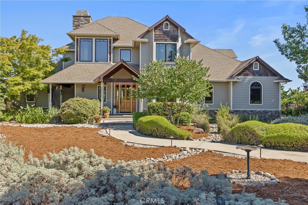 Welcome to 4669 Angelena Way, a breathtaking country estate tucked away on 9.92 lush acres, surrounded by your orchard of young almond trees, where luxury meets tranquility just minutes from town. This 2004-built retreat offers the ultimate balance of peaceful seclusion and everyday convenience. Spanning 2,897 sq. ft. this 4-bedroom home is more than just a place to live...it’s a lifestyle. From the moment you arrive, the grand entry invites you into a sunlit great room where vaulted ceilings, expansive windows, and serene views of the backyard oasis set the tone. At the heart of the home is the entertainer’s kitchen, a chef’s dream featuring granite countertops, a large island with built-in gas range, wall-mounted oven and microwave, abundant cabinetry, and seating at both the bar and breakfast nook. Whether hosting festive gatherings or enjoying quiet meals, this space brings everyone together. The main level’s smart split layout provides privacy and ease with a spacious guest suite and en-suite bath on one side, and the luxurious primary suite on the other, complete with dual sinks, a jetted soaking tub, a walk-in shower, and a generous walk-in closet. Upstairs, discover two more oversized bedrooms and a versatile bonus room with plenty of space for a library nook, home office, or additional sleeping quarters. Downstairs, the finished basement opens possibilities for a gym, game room, hobby studio, or creative escape. Step outside into your personal paradise: dive into the sparkling pool, dine under the pergola, grill in the built-in BBQ area, or harvest veggies from your raised garden beds. For guests or extended stays, the detached garage includes a fully outfitted upstairs loft with a kitchenette, bathroom, and sleeping area. A private sauna and an expansive owned solar system, featuring both roof-mounted and ground-mounted arrays, help power the property efficiently, offering remarkable energy savings year-round. This home was designed with heart, built with intention, and loved with care. Come experience the peace, beauty, and potential of this extraordinary retreat; you truly have to see it to believe it.