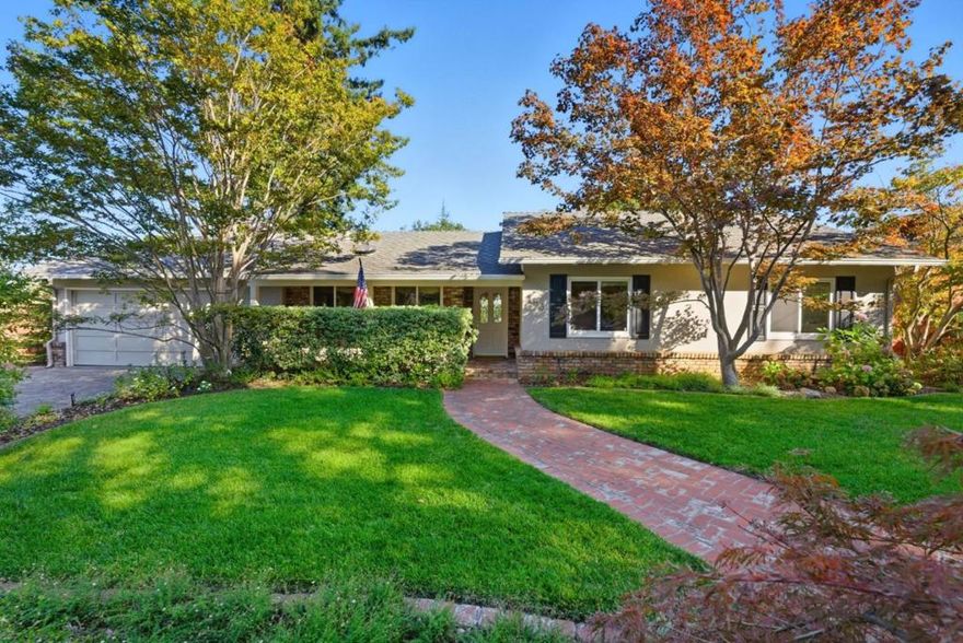 Tucked in a premier North Los Altos cul-de-sac, this warm and inviting single-level home blends classic appeal with modern updates, just minutes from the Village's shops, dining, and acclaimed Los Altos schools. Freshly updated and move-in ready, the home features elegant crown moldings, rich hardwood floors, and a rare 600-square-foot family room with vaulted ceilings and fireplace. Designed for effortless indoor-outdoor living and entertaining, the spacious living and dining area includes a cozy fireplace and built-in speakers. The well-appointed kitchen offers stainless steel appliances, wine refrigerator, abundant storage, and seamless flow to the living spaces. Three generous bedrooms include a serene primary suite with a built-in desk and a beautifully updated ensuite bathroom. The lush, professionally landscaped grounds create a private, picturesque setting that truly blurs the line between indoor comfort and outdoor enjoyment. Additional highlights include an oversized attached 2-car garage with a laundry area, and ample storage, Culligan soft water & drinking system, central air conditioning, secure oversized mailbox, a garden shed whose paint and roof shingles match those of the house, and gutter guards that keep the gutters clog-free year-round. Welcome home!