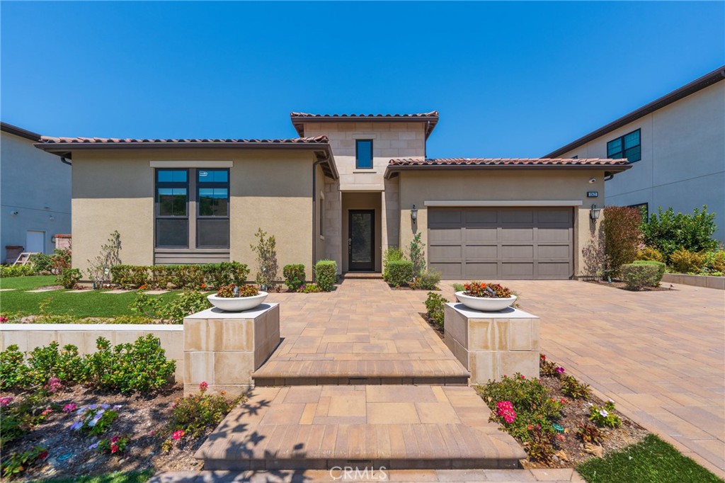 Experience modern Mediterranean elegance in this highly upgraded single-story home, perfectly situated in the coveted gated community of The Cove at Pacifica San Juan. Designed for seamless indoor-outdoor living, this residence offers an open-concept floor plan with soaring ceilings, expansive windows, and sophisticated finishes throughout.
The chef’s kitchen is an entertainer’s dream, showcasing European-style cabinetry, quartz countertops, premium stainless-steel appliances, an oversized island with seating and a built-in wine fridge, plus a walk-in pantry. The kitchen flows effortlessly into the spacious great room with a sleek linear fireplace, while wall-to-wall sliding glass doors open to the covered California Room for year-round gatherings.
The luxurious primary suite features a spa-inspired bathroom with dual vanities, a soaking tub, an oversized walk-in shower, and a custom walk-in closet. Additional highlights include a generous secondary bedroom, modern guest bath, and a fully equipped laundry room with sink and abundant cabinetry.
The backyard is an entertainer’s paradise, complete with a putting green, raised planter beds, and low-maintenance landscaping. Energy-efficient upgrades and a two-car garage.
Residents have privileged access to Club Pacific, where a resort-style saltwater pool, spa, private cabanas, state-of-the-art fitness center, outdoor fireplace, and barbeque areas create the perfect retreat. Meandering walking and biking trails weave through the community, leading to Adirondack chairs perfectly positioned to capture sweeping ocean and harbor views, the essence of coastal living.
All just minutes from Dana Point Harbor, world-class beaches, and charming downtown San Juan Capistrano.
