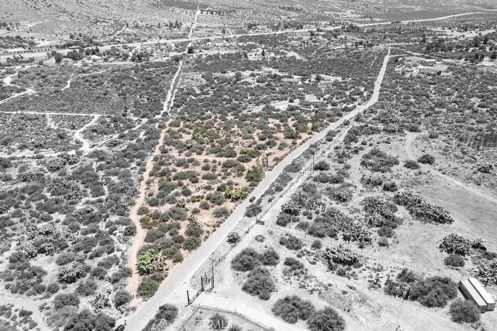 Rare opportunity to own 4.6 acres of flat land, placed on paved road-which is rare for the area- just a stone throws away from the 138 Highway, stunning 360 panoramic mountain views, and an endless amount of opportunities to create your own personal dream. Rarely does an opportunity like this ever become available to own 4.6 acres of prime, flat land, strategically positioned on paved road, making this a true once in a lifetime chance to own a unique highly desirable piece of property. With paved road frontage, this property offers a major advantage over most dirt road properties in the area making it a true 1-of-1 opportunity to own land that combines convenience, accessibility, and long-term value. Zoned RL (Rural Living), this property offers endless creative freedom—allowing you to imagine anything, build anything, and develop your personal dream. Whether it’s a custom home, a mobile home on a permanent foundation, ADUs, multiple units, agriculture, livestock, or even industrial use—this land supports it all. Grow crops, raise horses, roosters, chickens, or simply create your own private haven—the possibilities truly go on and on. Breathtaking, irreplaceable mountain views surround you in every direction offering unforgettable sunrises and sunsets that will leave you in awe, day after day. Just steps from Highway 138, this parcel offers unbeatable accessibility while still providing a peaceful, quiet, and private setting with plenty of room to grow and the potential for significant long-term value. Enjoy a variety of outdoor activities such as the mountain high ski resort in Wrightwood mountains, Silverwood Lake, Pacific Crest Trail stretching from Silverwood to Wrightwood, horseback riding, and ziplines at Pacific Crest. This is more than just land, it's a canvas for your dream lifestyle. Whether you're an investor, builder, or dreamer, this parcel offers the rare combination of prime location, easy access, flexible zoning and natural beauty—all just a short commute to Ontario Mills, Victoria Gardens, and Highway 15. Opportunities like this don’t come around often—make it yours before it’s gone!
