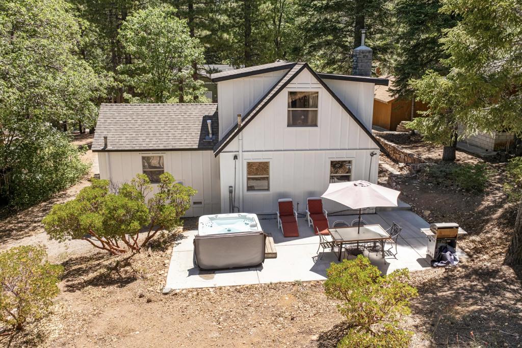 Step into a home that tells a story stretching back nearly a century--an enchanting and authentic Big Bear cabin that blends vintage charm with thoughtful updates. Tucked away on a huge, well-treed lot, this magical retreat offers a quiet, private setting just moments from the best of Big Bear: only 4 blocks to the lake, 5 blocks to the Village, and a mere 2 minutes to the ski slopes. National Forest access and the popular Town Trail are right around the corner. Inside, you'll find real wood floors, vaulted ceilings, and the warm glow of knotty pine T&G throughout. A beautiful rock fireplace anchors the living space, perfect for cozy winter evenings. The updated kitchen features new cabinets and stylish finishes, while the bathroom has been refreshed with a new sink and copper piping. A tankless water heater adds modern convenience, and a newer concrete patio off the back invites you to relax under the pines in your secluded backyard. With a bedroom and full bath on the main level plus a spacious loft-style suite upstairs, this cabin is ideal as a full-time home, weekend getaway, or vacation rental with excellent income potential. Fresh brand-new siding gives the home a crisp look while preserving its original spirit. This is more than a cabin--it's a piece of Big Bear history, lovingly refreshed for the next chapter. Whether you're hitting the slopes, hiking out your front door, or strolling to dinner in the Village, the location couldn't be more perfect. Don't miss this rare opportunity to own a true mountain gem.