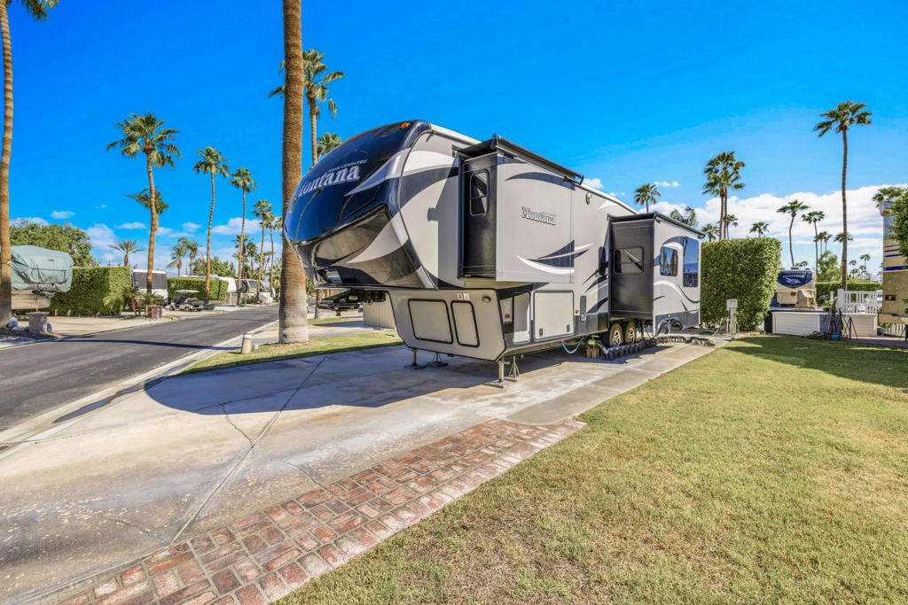 What's great about this lot? Its a terrific corner lot located across from the pool and spa. Capture gorgeous San Jacinto mountain views from the lot and also from interior of rv. Easy carefree low maintenance lot. Laundry and full restroom facilities also just steps away. Located adjacent to a greenbelt so no neighbor directly to the right. Private location and such a great price for the location and a corner lot.