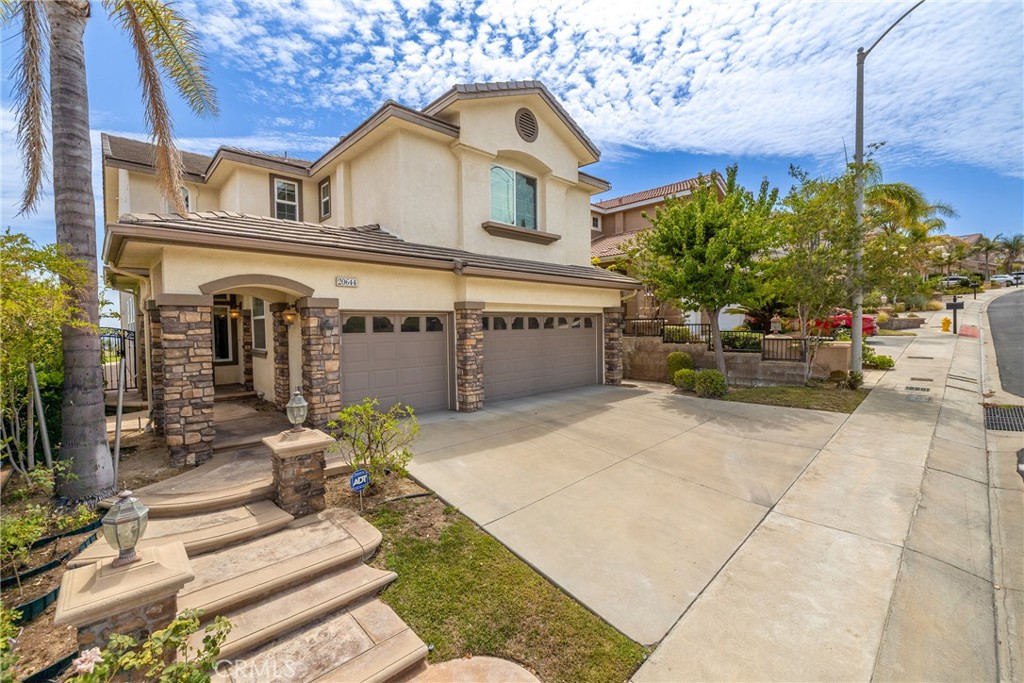 Don't Miss this Stunning 4 Bedroom 4.5 Bath Home with a Spectacular View in the beautiful Guard-Gated Sorrento Community of Porter Ranch. Step into this Bright and Spacious Home to the Living Room with Soaring 2 story Ceiling with Gleaming Wood Flooring. Features Also include a Formal Dining and Views from the Gorgeous Kitchen with Breakfast Area and Family Room with Fireplace. You will also find a Bedroom with it's own Bathroom Downstairs, in addition to a Guest Bathroom. Huge Master Suite with Luxurious Master Bath also have Amazing views and also includes a large Walk-in Closet. Upstairs are Two Additional Bedrooms, one with its own Bathroom and the other shares an ample sized hall Bathroom with a Large Bonus Room great for a game room, office space, den, gym, etc. The nicely Landscaped Rear Yard has a Panoramic View of the Valley and City Lights. This home is located conveniently across from the community pool. Just around the corner from The Vineyards in Porter Ranch, which features a Movie Theatre, Whole Foods, Shopping, Restaurants and more.