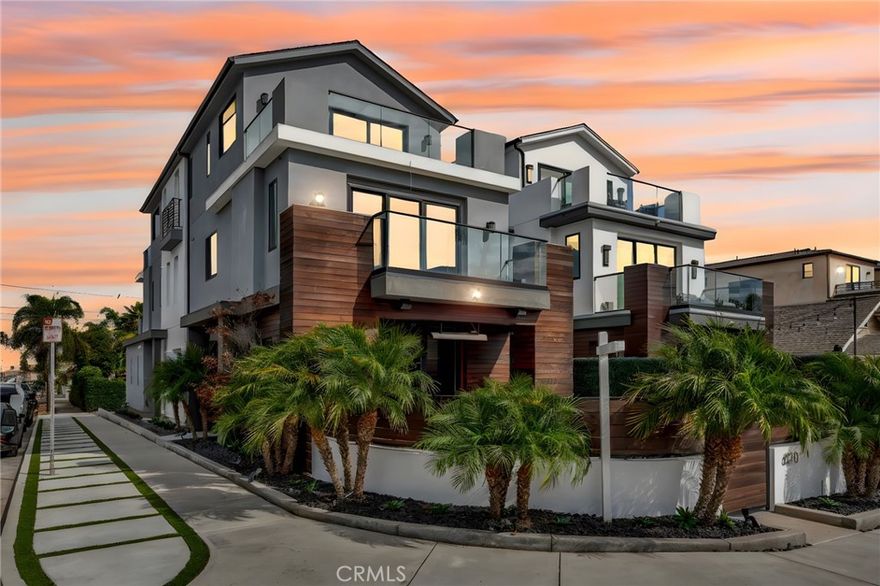 Exquisitely designed tri-level beach residence, perfectly situated on an oversized, coveted, sunny corner lot just minutes from the sun-drenched sands and vibrant lifestyle of Downtown Huntington Beach. This sophisticated home built in 2021 spans over 3,300 square feet of thoughtfully curated living space and features a private elevator for effortless access to all levels. Bathed in natural light from expansive windows, the open-concept main level exudes warmth and elegance, enhanced by recessed lighting, high ceilings, a sleek cozy fireplace with integrated surround sound and oversized bi-fold patio doors open to an exceptional outdoor sanctuary, creating an ideal setting for indoor/outdoor year-round entertaining. The dining area, featuring a built-in wine display, seamlessly flows into the chef’s kitchen, appointed with premium Wolf stainless steel appliances, a spacious walk-in pantry, and a center preparation island with bar seating. The second level offers a versatile media or bonus room (easily converted to 4th bedroom), alongside two large bedrooms, including a primary suite designed for ultimate retreat living. The 3rd level features a second primary suite with a dedicated seating area with a built-in desk, a spa-inspired bath with dual vanities, soaking tub, walk-in shower, and a custom-designed walk-in closet. Each additional bedroom offers generous proportions and refined finishes. As well as a office perfect for a lounge, home office, or 5th bedroom, with an attached half bath, with direct access to expansive rooftop decks that elevate the indoor-outdoor experience. The 2 car garage is fully finished with epoxy flooring and built-in storage. Additional appointments include solar panels, 1st & 3rd floor ductless HVAC, 2nd floor individual climate control per room, automated blinds, tinted windows, a Savant smart home system, and Ring security cameras. This residence masterfully combines modern coastal sophistication, convenience, and refined luxury living in one unparalleled package all just a short walk to the beach, downtown Huntington Beach, the pier, Pacific City and more!