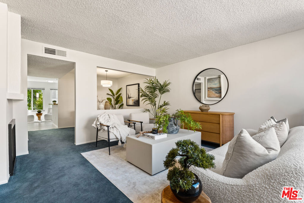 Discover a rare opportunity to own a beautifully designed two-bedroom, three-bathroom townhome-style condo in the sought-after Royal Topanga development. Spanning 1,362 sq. ft., this residence blends comfort, style, and convenience, offering the feel of a private retreat just moments from some of the best shopping and entertainment the Valley has to offer. Step inside to find a generous living room with a cozy fireplace, a formal dining area, and a sunlit kitchen that opens seamlessly to the family room with a breakfast bar - perfect for casual dining and entertaining. The home features two inviting living areas, creating versatile spaces to relax, work, or host. Upstairs, discover two expansive bedrooms with walk-in closets, including a primary suite designed for rest and privacy. Additional conveniences include in-unit laundry, central air conditioning, and two secure underground parking spaces. Enjoy California living on your private patio or within the community's meticulously landscaped grounds, complete with a sparkling pool and spa. The complex also offers 24-hour closed-circuit security surveillance, ensuring peace of mind. Ideally located, this home is just minutes from Westfield Topanga Mall, The Village at Topanga, and easy freeway access to the 101 and 118connecting you quickly to the best of Los Angeles. A perfect blend of comfort, security, and convenience, this Royal Topanga residence is ready to welcome you home.