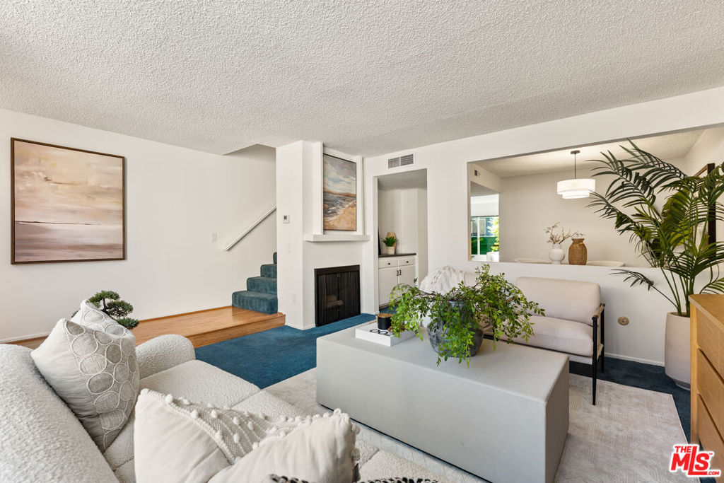 Discover a rare opportunity to own a beautifully designed two-bedroom, three-bathroom townhome-style condo in the sought-after Royal Topanga development. Spanning 1,362 sq. ft., this residence blends comfort, style, and convenience, offering the feel of a private retreat just moments from some of the best shopping and entertainment the Valley has to offer. Step inside to find a generous living room with a cozy fireplace, a formal dining area, and a sunlit kitchen that opens seamlessly to the family room with a breakfast bar - perfect for casual dining and entertaining. The home features two inviting living areas, creating versatile spaces to relax, work, or host. Upstairs, discover two expansive bedrooms with walk-in closets, including a primary suite designed for rest and privacy. Additional conveniences include in-unit laundry, central air conditioning, and two secure underground parking spaces. Enjoy California living on your private patio or within the community's meticulously landscaped grounds, complete with a sparkling pool and spa. The complex also offers 24-hour closed-circuit security surveillance, ensuring peace of mind. Ideally located, this home is just minutes from Westfield Topanga Mall, The Village at Topanga, and easy freeway access to the 101 and 118connecting you quickly to the best of Los Angeles. A perfect blend of comfort, security, and convenience, this Royal Topanga residence is ready to welcome you home.