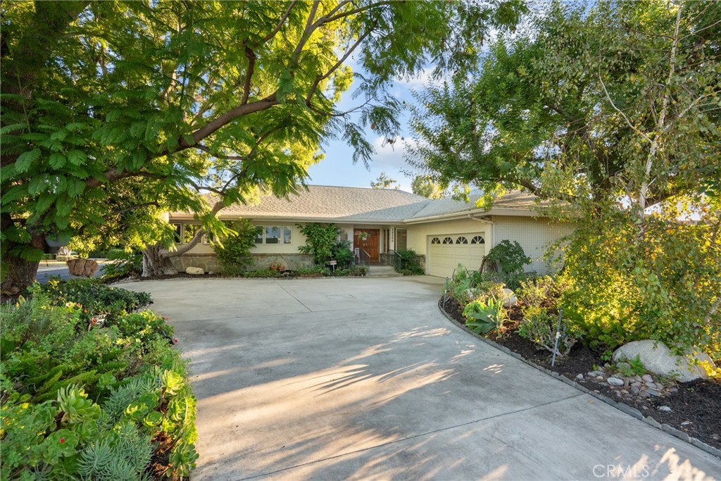 Welcome to 19200 Ballinger Street, a classic California residence tucked within the prestigious Château Highlands neighborhood. Lovingly cared for by the same family for more than six decades, this timeless property rests on a beautifully landscaped 17,500 sq ft corner lot framed by mature trees and lush gardens — offering both privacy and an enduring sense of warmth.Inside, you’ll find five generously sized bedrooms and three tastefully updated bathrooms, blending modern comfort with mid-century charm. The remodeled kitchen features custom cabinetry, granite countertops, and updated stainless steel appliances — a perfect gathering spot that opens to the inviting dining and living spaces. The updated baths provide a fresh, spa-like experience with elegant finishes and thoughtful design.The spacious living room with its cozy fireplace and custom built in shelves, creates a natural flow between the indoors and the serene outdoor setting.Primary suite is generous in size with a great view of the rear yard and patio deck, stunning large updated bathroom with separate bath and oversized shower, bidet and toilet. Elegant and nicely planned. Step outside to your private resort-style retreat — complete with a solar thermal-heated, covered pool and electric safety cover, ideal for swimming year-round. The expansive backyard also offers a pickleball/sport court, garden areas, and multiple patios for relaxing, entertaining, or enjoying the sunshine in peaceful seclusion. Additional highlights include a circular driveway, ample parking, and fantastic curb appeal that perfectly complements the charm and character of this distinguished neighborhood. Numerous upgrades include fully paid for solar system this helps keep the utilities affordable, Solar Thermal system to heat the pool water, sub water meter, Roof 2017, new HVAC ( one of the 2 units), copper pipes, lush drought tolerant landscaping and three nearby cul de sacs and more. 19200 Ballinger Street represents a rare opportunity to own a true legacy property in one of the Valley’s most desirable enclaves — where comfort, character, and location unite to create a place you’ll love calling home.