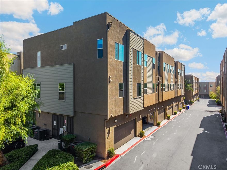 Enjoy modern, low-maintenance living in this stylish End-Unit condo built in 2017, located in the desirable Upland Central Live/Work community. The first floor features a private bedroom with ensuite bath, perfect for guests or a home office, plus a patio and direct access to the two car garage with a tankless water heater. The open-concept main level offers soaring ceilings, a bright living and dining area with balcony, ceiling fan, and a contemporary kitchen with quartz countertops, stainless steel appliances, pull-out shelving, walk-in pantry, island with breakfast bar, pendant lighting, and guest half bath. Upstairs, the spacious guest bedrooms and primary suite includes high ceilings, a walk-in closet  and luxurious ensuite with dual sinks and quartz countertops. Additional highlights include ceiling fans throughout, custom window coverings, recessed lighting, upgraded tile floors and stone counters, custom paint,  an upstairs laundry room, and access to gated community amenities such as a pool, BBQ areas, outdoor dining, comfortable seating areas and fire pits.  All just minutes from Claremont Village, shopping, dining, top schools, and major freeways.