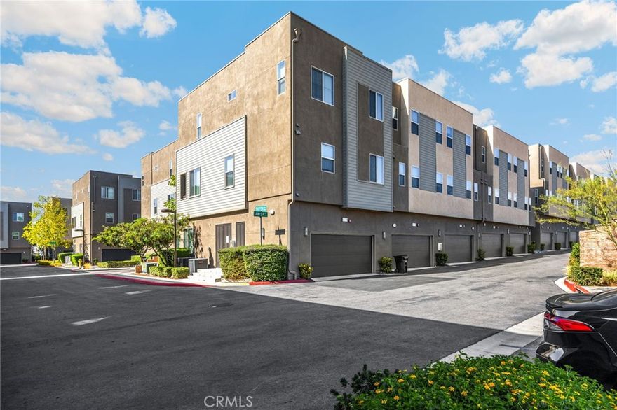 Enjoy modern, low-maintenance living in this stylish End-Unit condo built in 2017, located in the desirable Upland Central Live/Work community. The first floor features a private bedroom with ensuite bath, perfect for guests or a home office, plus a patio and direct access to the two car garage with a tankless water heater. The open-concept main level offers soaring ceilings, a bright living and dining area with balcony, ceiling fan, and a contemporary kitchen with quartz countertops, stainless steel appliances, pull-out shelving, walk-in pantry, island with breakfast bar, pendant lighting, and guest half bath. Upstairs, the spacious guest bedrooms and primary suite includes high ceilings, a walk-in closet  and luxurious ensuite with dual sinks and quartz countertops. Additional highlights include ceiling fans throughout, custom window coverings, recessed lighting, upgraded tile floors and stone counters, custom paint,  an upstairs laundry room, and access to gated community amenities such as a pool, BBQ areas, outdoor dining, comfortable seating areas and fire pits.  All just minutes from Claremont Village, shopping, dining, top schools, and major freeways.
