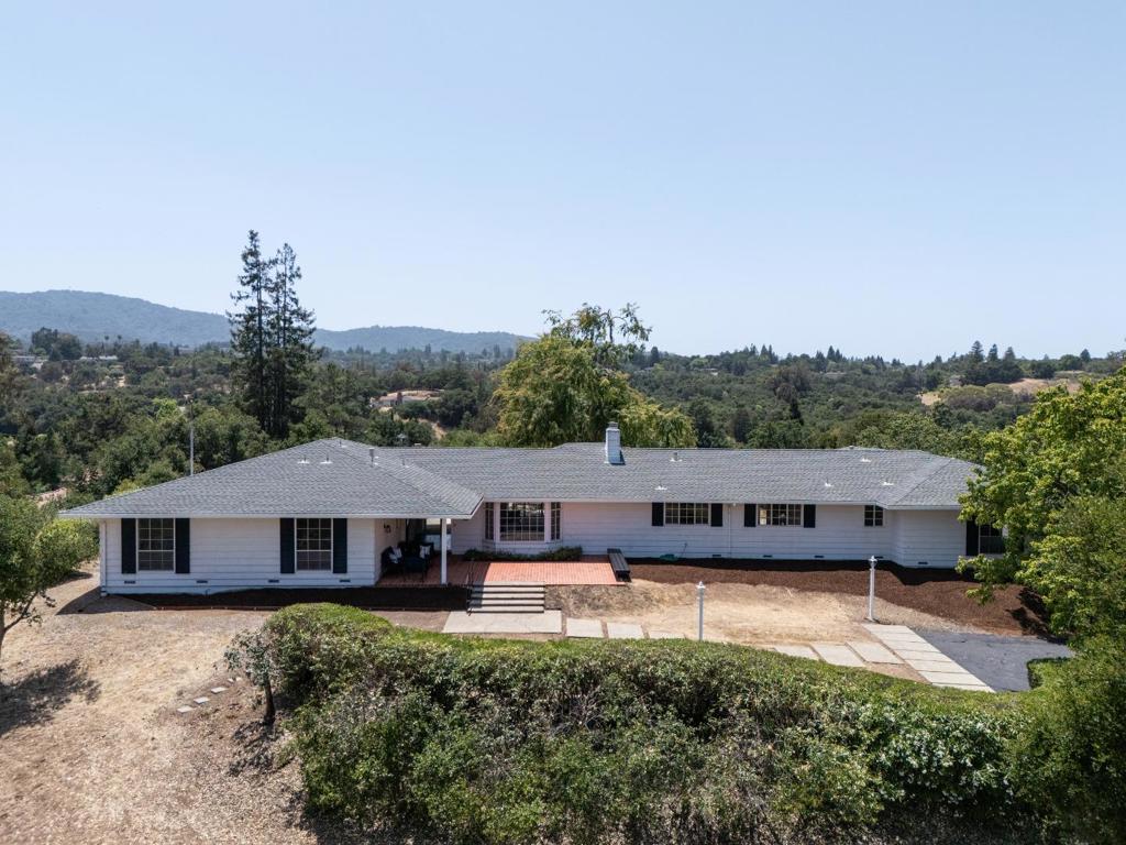 This elegant ranch-style home has been a haven for one family for over 60 years. Nestled atop a gentle knoll at the end of a cul-de-sac close to downtown Los Altos, it was lovingly chosen for its wonderful views and tranquil surroundings. Survey calculations show 5,599 SF MFA and 12,830 SF MDA. Upon arriving via the lush welcoming driveway, you are greeted by its serene ambiance and the sunlit front patio with a built-in bench. This residence boasts expansive interiors, highlighted by a generously sized living/dining room with sliding doors leading to the rear patio, an office-bonus room w/sink , and large family room. Positioned on a partially level lot, this home offers various planting areas ready with near 360 degree views. Conveniently located to Fremont Hills Country Club, Pinewood High School and walking paths to the Village of Los Altos. Whether you envision a loving restoration or a complete rebuild, this extraordinary home eagerly awaits to fulfill your dream home aspirations.
