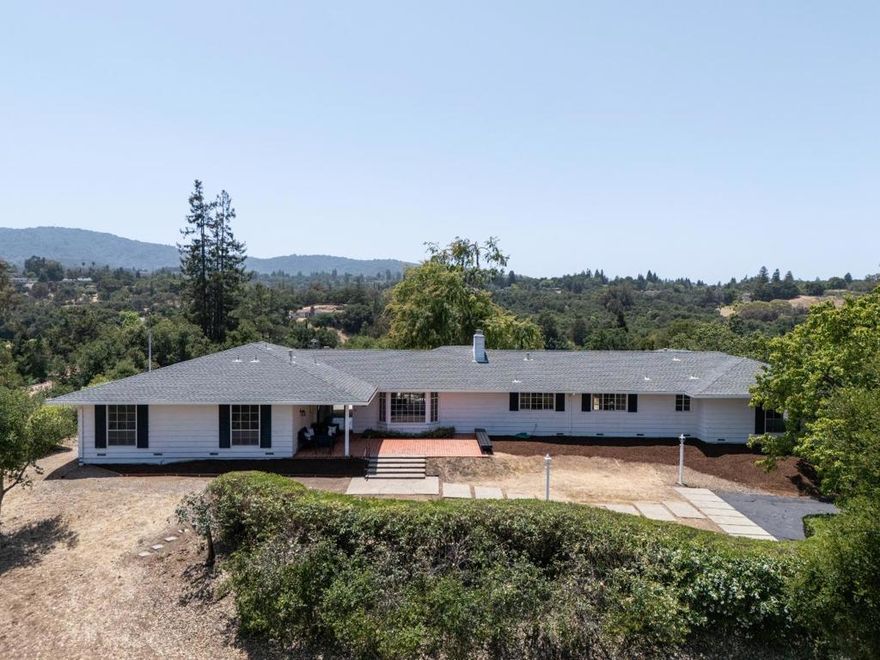 This elegant ranch-style home has been a haven for one family for over 60 years. Nestled atop a gentle knoll at the end of a cul-de-sac close to downtown Los Altos, it was lovingly chosen for its wonderful views and tranquil surroundings. Survey calculations show 5,599 SF MFA and 12,830 SF MDA. Upon arriving via the lush welcoming driveway, you are greeted by its serene ambiance and the sunlit front patio with a built-in bench. This residence boasts expansive interiors, highlighted by a generously sized living/dining room with sliding doors leading to the rear patio, an office-bonus room w/sink , and large family room. Positioned on a partially level lot, this home offers various planting areas ready with near 360 degree views. Conveniently located to Fremont Hills Country Club, Pinewood High School and walking paths to the Village of Los Altos. Whether you envision a loving restoration or a complete rebuild, this extraordinary home eagerly awaits to fulfill your dream home aspirations.