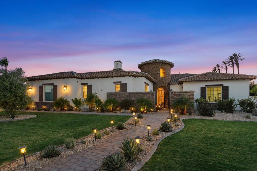 Introducing a rare opportunity to own an upscale Italian Country Estate in the prestigious community of Stonefield Estates. This luxurious 5Bed/5Bath 4,868 sq . home with a 2-room casita suite sits on a half-acre lot. Designed for refined desert living, this well-appointed home features porcelain tile floors and dramatic natural light throughout. From the moment you walk through the custom wrought-iron entry gate and rotunda, the home's elegance and thoughtful design for entertaining unfold. The formal living room/dining room features 14' ceilings with wood beams, large fireplace and custom built-in display cabinets. The gourmet chef's kitchen has a 48'' Sub-Zero, 48'' Wolf range & built-in microwave, and Bosch dishwasher. It features European maple cabinetry, an oversized center island with seating for 6+ persons, quartz counters, eating area and a huge walk-in pantry. It flows into the spacious Family Room with fireplace and bar - perfect for entertaining. The expansive primary suite with built-ins and stepped ceilings provides mountain views and access to the outdoor entertainment area. The spa quality primary bath features dual vanities, marble counters, soaking tub, tiled shower, and custom closet built-ins. The main house includes two additional ensuite guest rooms, an additional bedroom (being used as an office), and a fully renovated powder room. The separate 2-room Casita features a living area with fully renovated kitchenette, bedroom, walk-in closet, full bathroom, 2-sided fireplace, and ceiling fans. It offers privacy and comfort for visitors and/or caregivers with separate entrance from the main house. The private Atrium between the main house and casita features a beautiful private dining area. The backyard oasis is equally impressive and includes a saltwater pool & spa, and a sitting area with a large firepit. The covered loggia features a built-in grill, commercial hood, ceiling fans, TV, and large seating & dining areas with retractable awnings. This fully renovated landscaped property includes a new irrigation system with mature citrus and pomegranate trees. A pool house with 220v power is ready for a mini-split A/C. Upgrades are too many to list, but include a 26kw Generac whole-house generator, whole-house water filtration with reverse osmosis system, ADT security system with cameras, and custom motorized window treatments throughout. This home also includes dual-zone A/C with add'l separate units for the Casita and the four-car garage