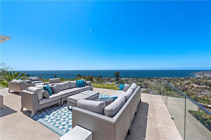 Welcome to a one-of-a-kind Laguna Beach retreat where style, privacy, and jaw-dropping views converge. Resting on a hilltop promontory along Summit Drive, this extraordinary contemporary residence was crafted by Morris Skenderian and offers uninterrupted panoramas of ocean waves, coastline cliffs, sparkling city lights, and serene hillsides. Every space of the home was designed to impress-walls of glass dissolve into open-air terraces, creating a seamless indoor-outdoor lifestyle. Entertain in grand style on the 1,000 sq. ft. travertine patio with sweeping lawns, or retreat to your private ocean-view fitness area for quiet reflection. The updated kitchen gleams with custom finishes, while dual primary suites promise comfort, luxury, and their own unforgettable vistas. Professionally landscaped and tucked away with no immediate neighbors, this residence provides a sense of true escape while remaining moments from the vibrant culture of Laguna Beach. An iconic lease offering unlike anything else on the coast.