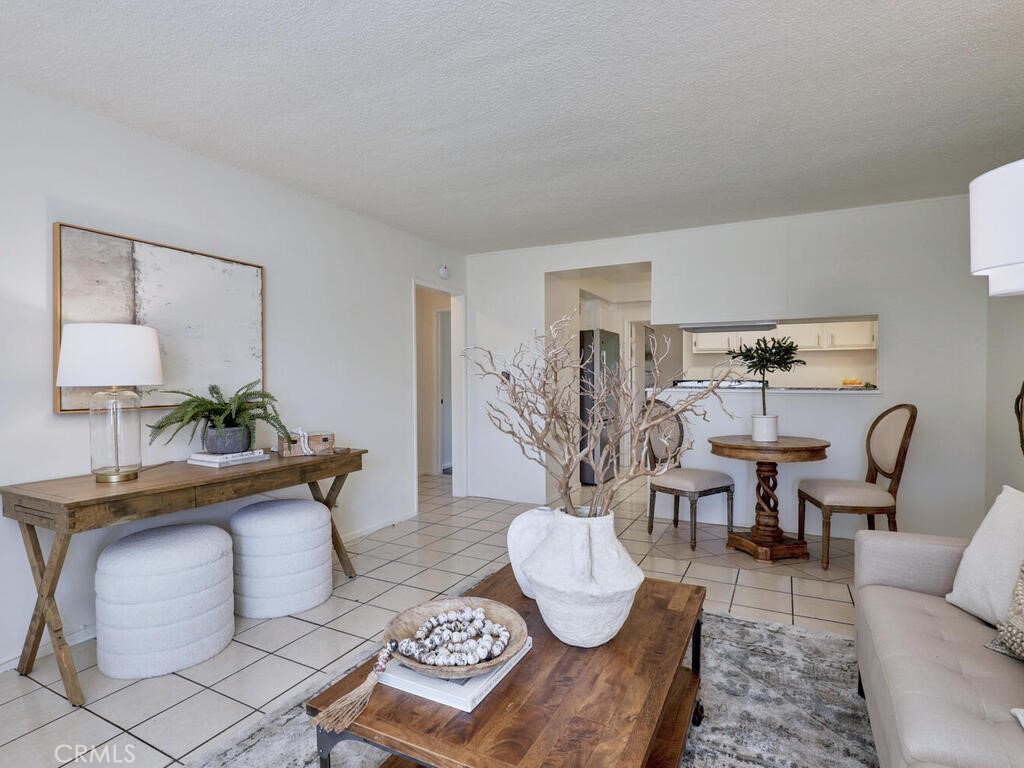 Wonderful opportunity to own a spacious single-story condo in the desirable gated community of The Bahamas in Tustin. This end unit offers over 1000 square feet of living space with no steps and no one above or below. The open floor plan features two large bedrooms plus a versatile third room that can be used as a den, home office, or potential third bedroom.
The expansive living room flows seamlessly into the dining area and kitchen, creating an ideal layout for entertaining. The kitchen includes granite countertops, ample cabinet and counter space and a pantry. The home features tile flooring throughout the main living areas and wood-style laminate flooring in the bedrooms. The generous primary suite includes an en suite bathroom and access to the private patio.
An additional full guest bathroom adds convenience, and the charming patio opens to the beautifully maintained courtyard and community pool. Parking and community is gated, you get one carport and one parking permit. It is perfect for relaxing or gathering with family and friends. This well-kept community offers low Taxes & HOA dues, covering water, trash, and sewer.
Located near shopping, dining, and major freeways including the 5 and 55, this home combines comfort, convenience, and charm in one of Tustin’s most sought-after communities. Professional Photos and Video Coming Soon.