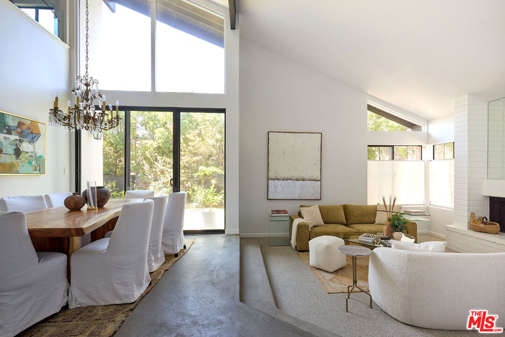 Welcome home to 10862 Garland Drive. If you've been dreaming of a sun-drenched home that perfectly balances style and comfort, your search ends here. This Studio Estates gem sits on a peaceful cul-de-sac, giving you a small-town feel while keeping you connected to everything you love about the big city. From the moment you step inside, you'll fall in love with how the natural light dances through every room: gentle morning rays in the kitchen, and a magical golden hour glow that bathes the front living area. With three comfortable bedrooms, a versatile loft space featuring a clever Murphy bed, and multiple spots designed for gathering with friends and family, this home grows with your lifestyle. The attached two-car garage leads into a stunning double-height living area that immediately makes you feel at home. When you need a quiet moment, slip away to the charming sunroom or step outside to your own private oasis complete with mature fruit trees and a fire pit perfect for evening conversations under the stars. The location couldn't be better! You can easily access neighborhood favorites while being just minutes from top-rated schools, beautiful parks, and all that downtown Culver City offers. Veterans Park is practically in your backyard, with pickleball courts, tennis, basketball, and a refreshing outdoor pool waiting for you.