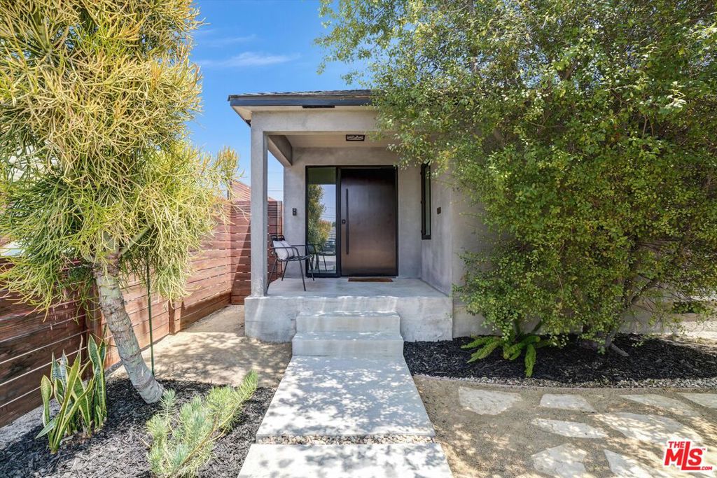 Welcome home to 3558 S. Muirfield Rd. located in historical Crenshaw Manor nestled in West Adams. This home has been exquisitely reinvented to meet your every living and entertainment need to include an oversized open living space, custom kitchen, cabinetry, a 9'x4' island with Brazilian Aquarela stone and backsplash, a six-burner cooktop and range hood, double ovens and a custom bar cabinet. Home has two large suites, both with custom 5-piece baths: dual sinks, walk-in shower and soaking tub. Enter past your new fully landscaped yard thru a custom pivot door. The rear dual glass framed door, and casement windows are by Western. The home has consistent red oak hardwoods throughout, a dedicated laundry room and custom closet cabinetry. The garage is partially finished and has updated electrical. Newer roof (2017), central air and heat, tankless water heater, full electrical rewire and upgraded to 200 amps (with an additional box). The foundation is reinforced and strapped. Book your tour. This one won't last!