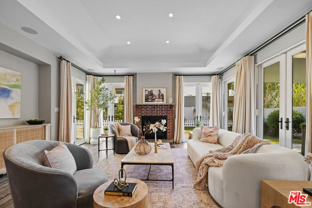 Step into a home that has it all. Style, function, and modern upgrades in every corner. Featuring a brand new HVAC system, new water heater, and a whole-home water softening system, this stunning single-level home is truly move-in ready. Soaring high ceilings, multiple skylights, and elegant floor-to-ceiling custom drapery fill the home with light and luxury. Enjoy built-in surround sound throughout and an entertainer's dream layout with seamless indoor-outdoor flow. The gourmet kitchen is a showstopper with a massive center island, double oven, premium Bosch appliances, and tons of storage. The side-by-side layout offers space and privacy, while endless built-in storage keeps everything organized and out of sight. Retreat to your private primary suite with its own covered patio, spa-inspired bathroom, and a walk-in closet. Hosting is a breeze with indoor and outdoor entertaining areas, perfect for gatherings of any size. Outside, the drought-resistant front yard welcomes you with a serene Zen pond, while the sizable backyard offers plenty of room to relax, entertain, or even build a future pool. Minutes to major studios, shopping, dining, parks, etc. This is more than a home, it's your forever sanctuary, thoughtfully upgraded, beautifully maintained, and ready for you.